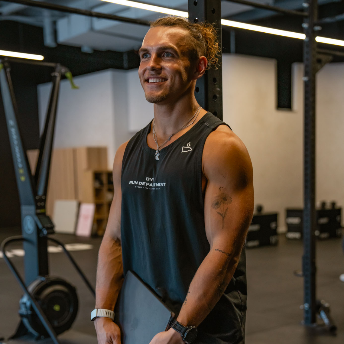 FitPro student holding a weight plate