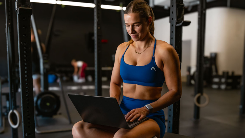FitPro student studying on a laptop in the gym