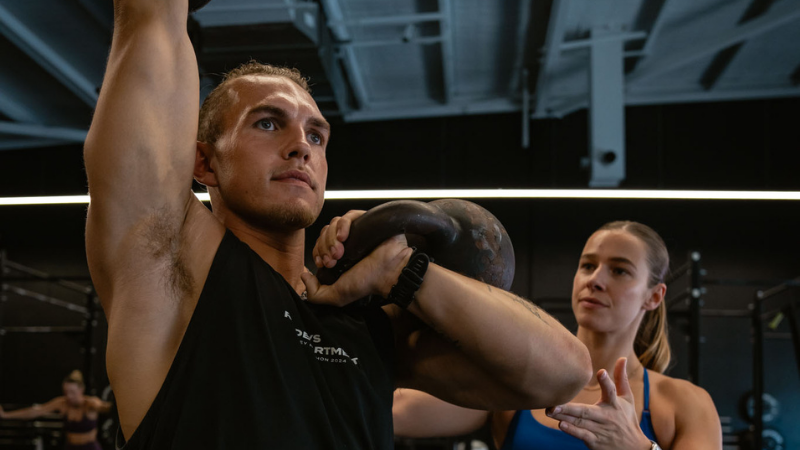 FitPro personal trainer coaching a client