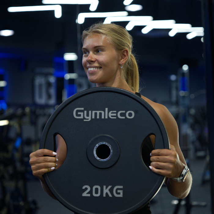 FitPro student holding a weight plate