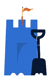A sandcastle with a shovel beside it