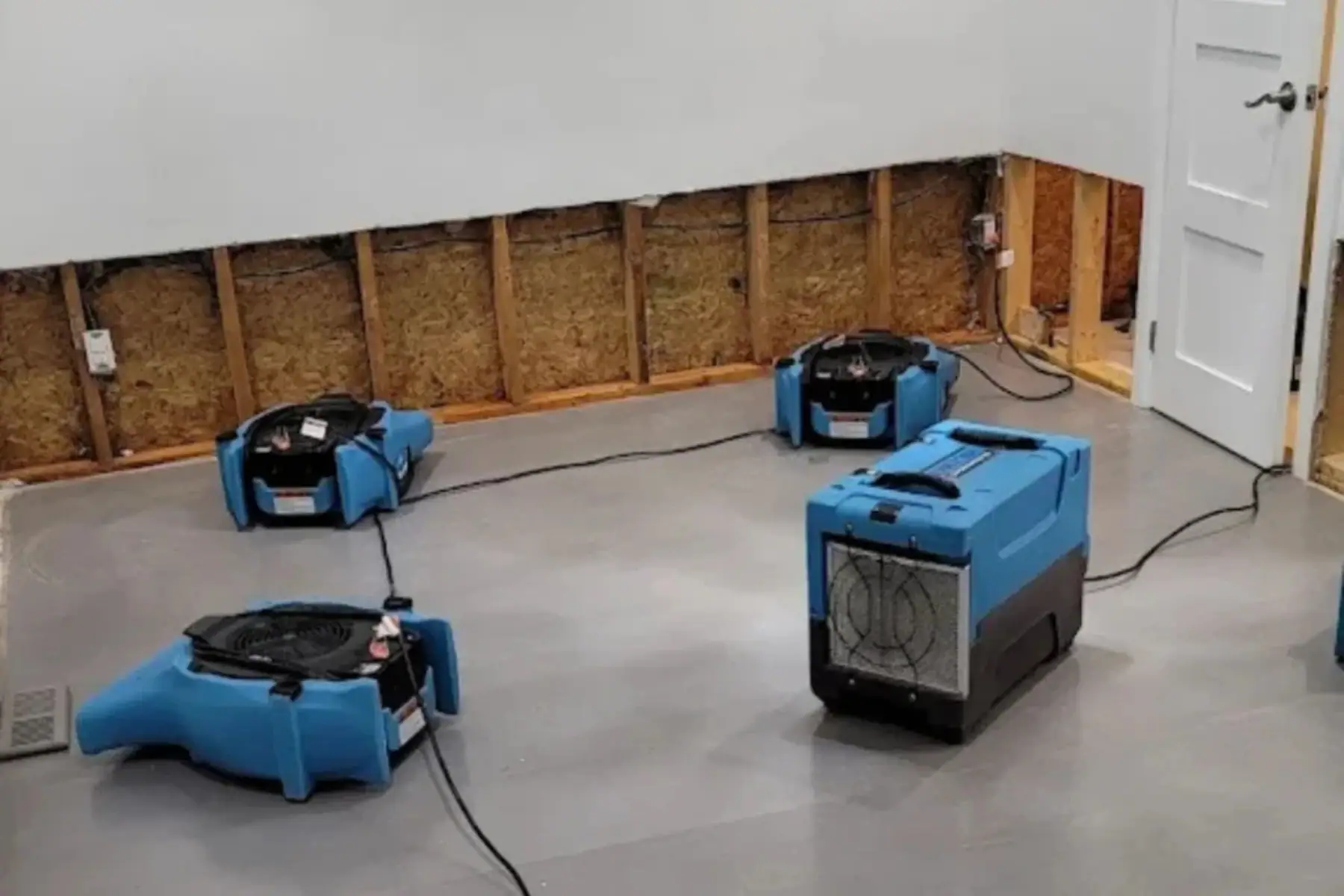 Water damage basement with drying fans