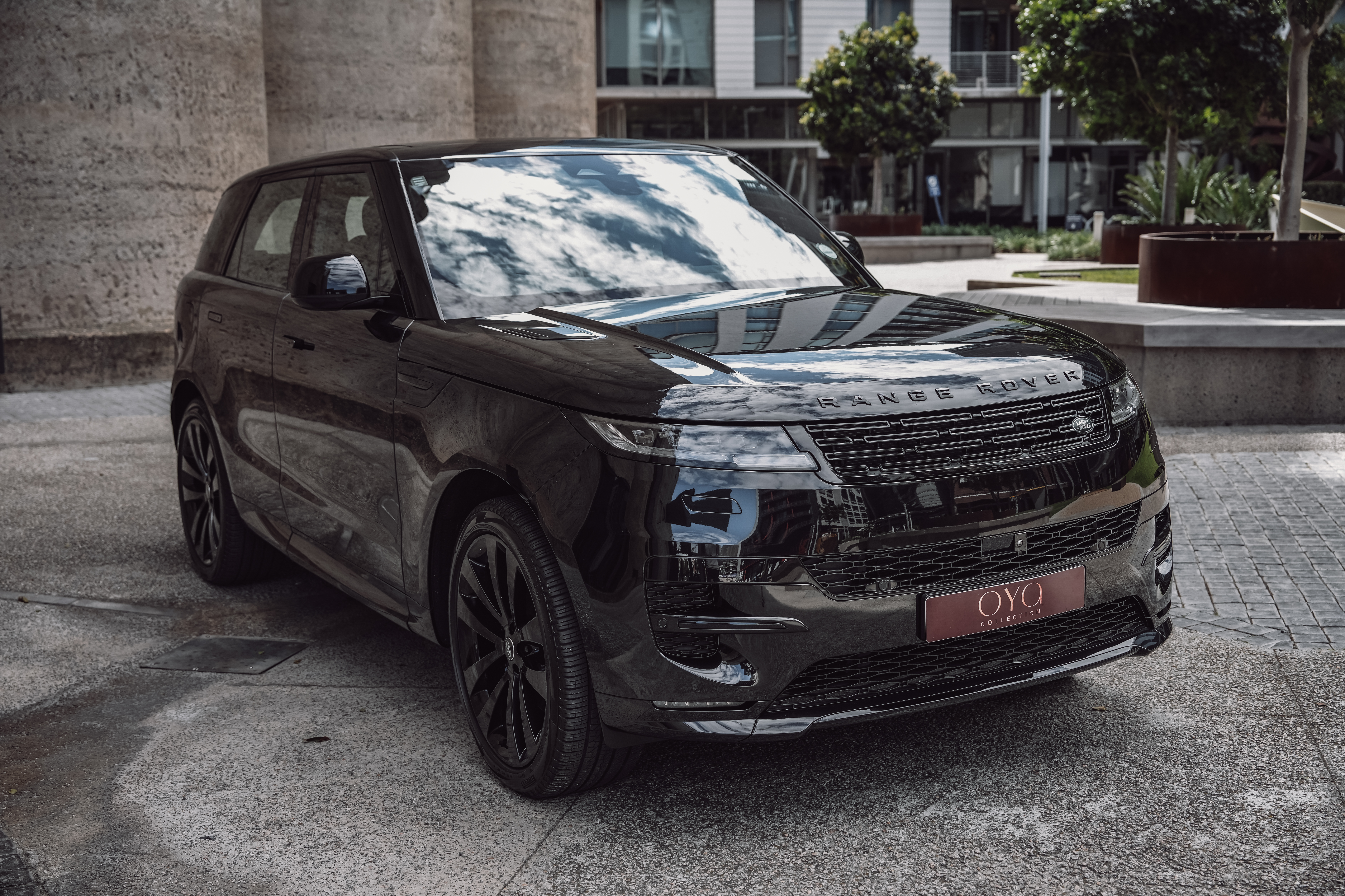 Black 2023 Range Rover Sport parked in an urban setting.