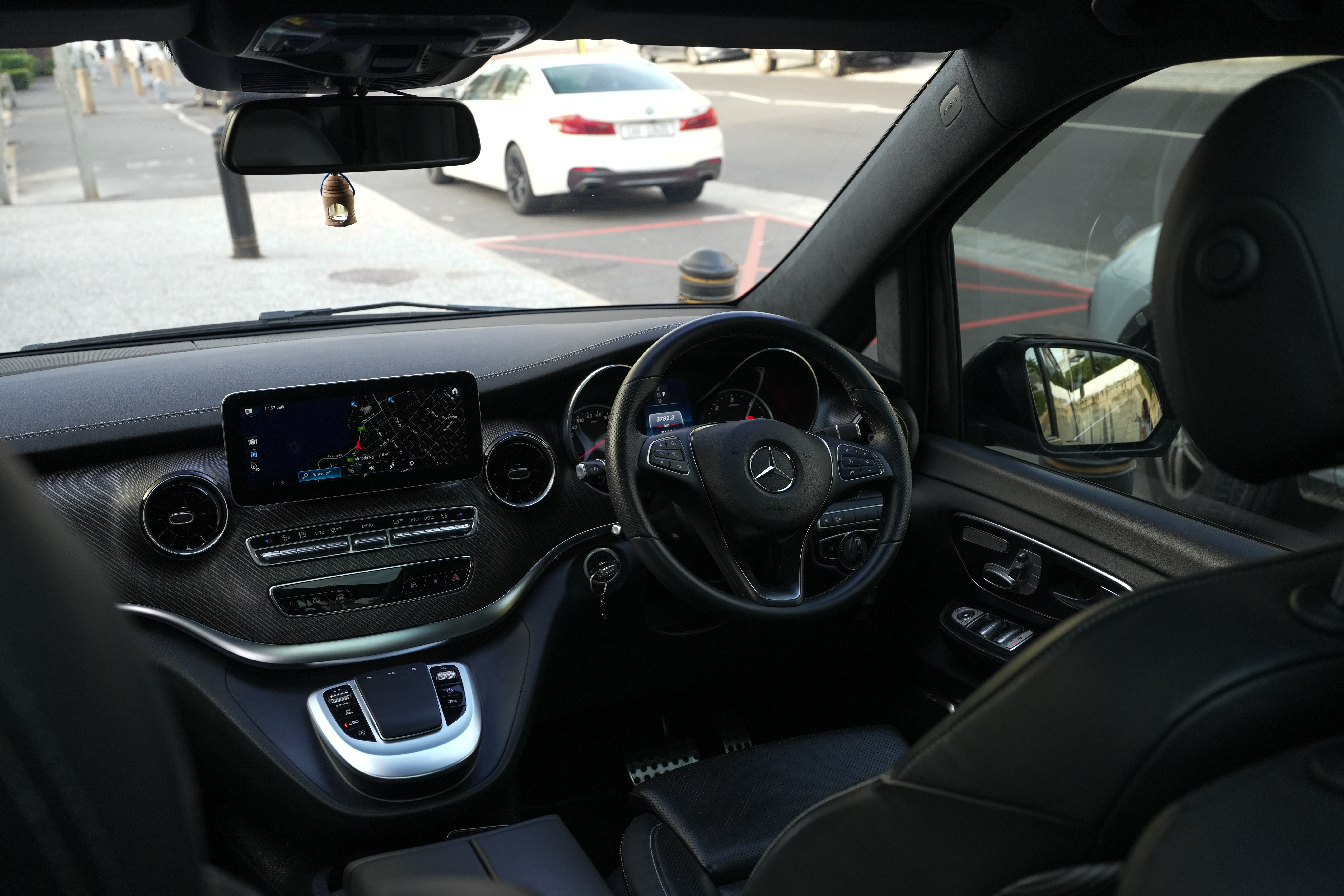 Black 2024 Mercedes-Benz V-Class V300d rear or angled exterior view.