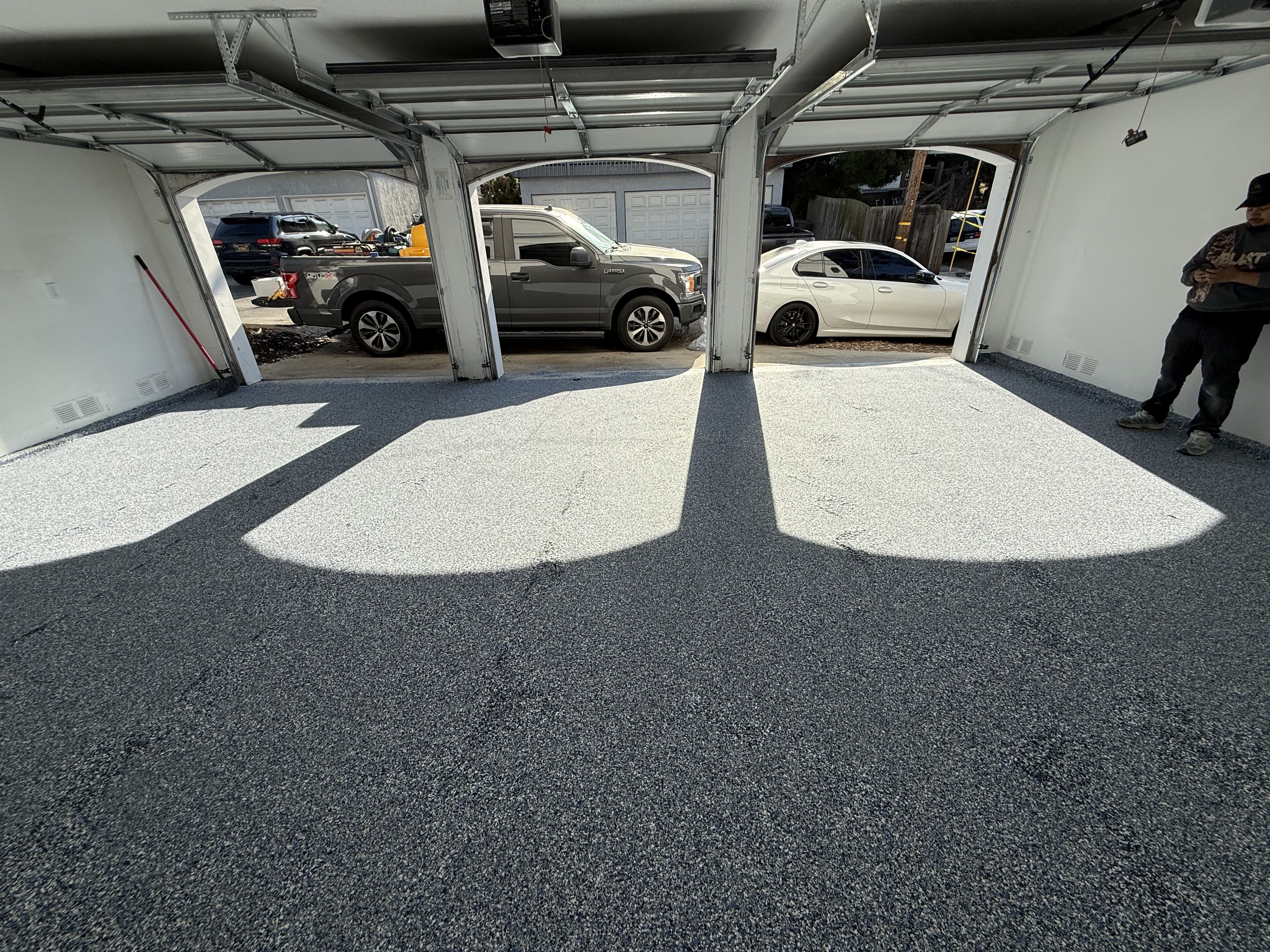 Organized three-car garage with gray flake epoxy floor