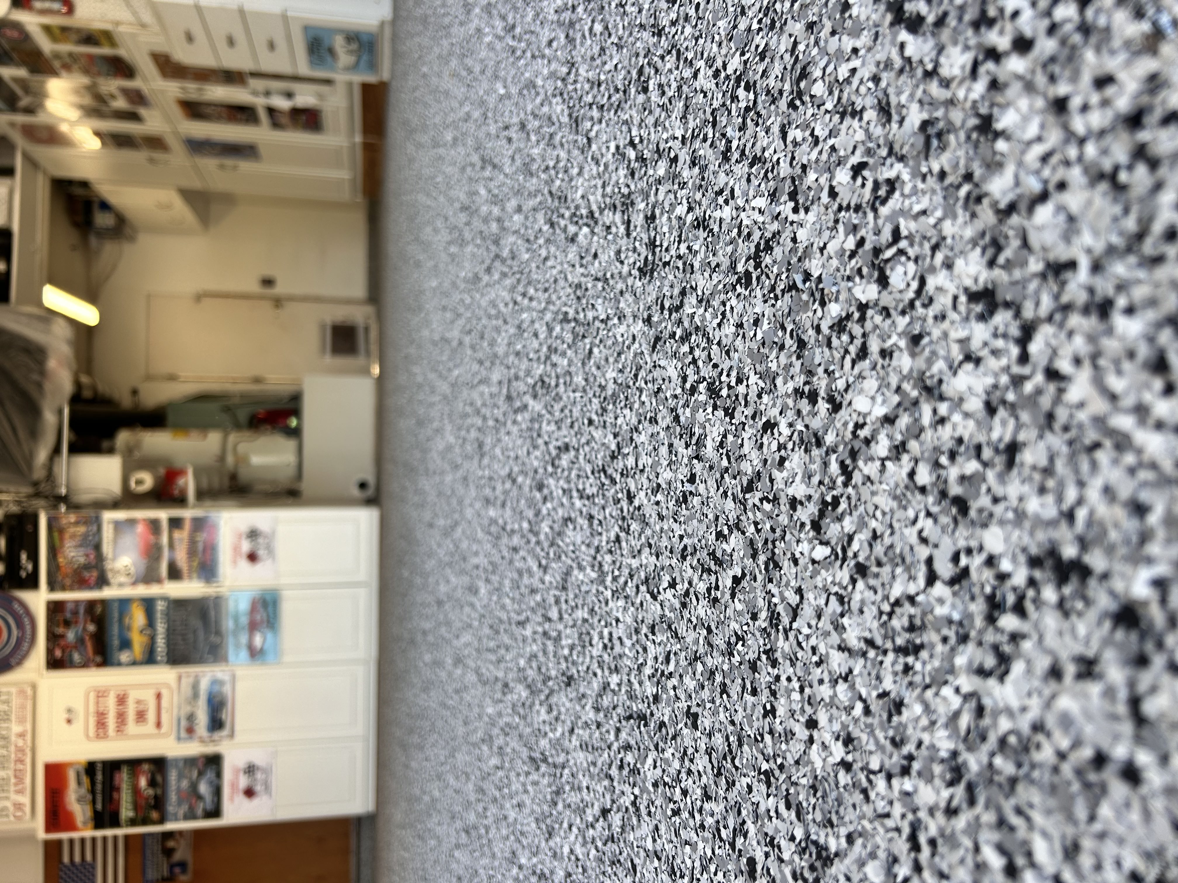 Blue-white metallic epoxy residential floor with vaulted ceiling