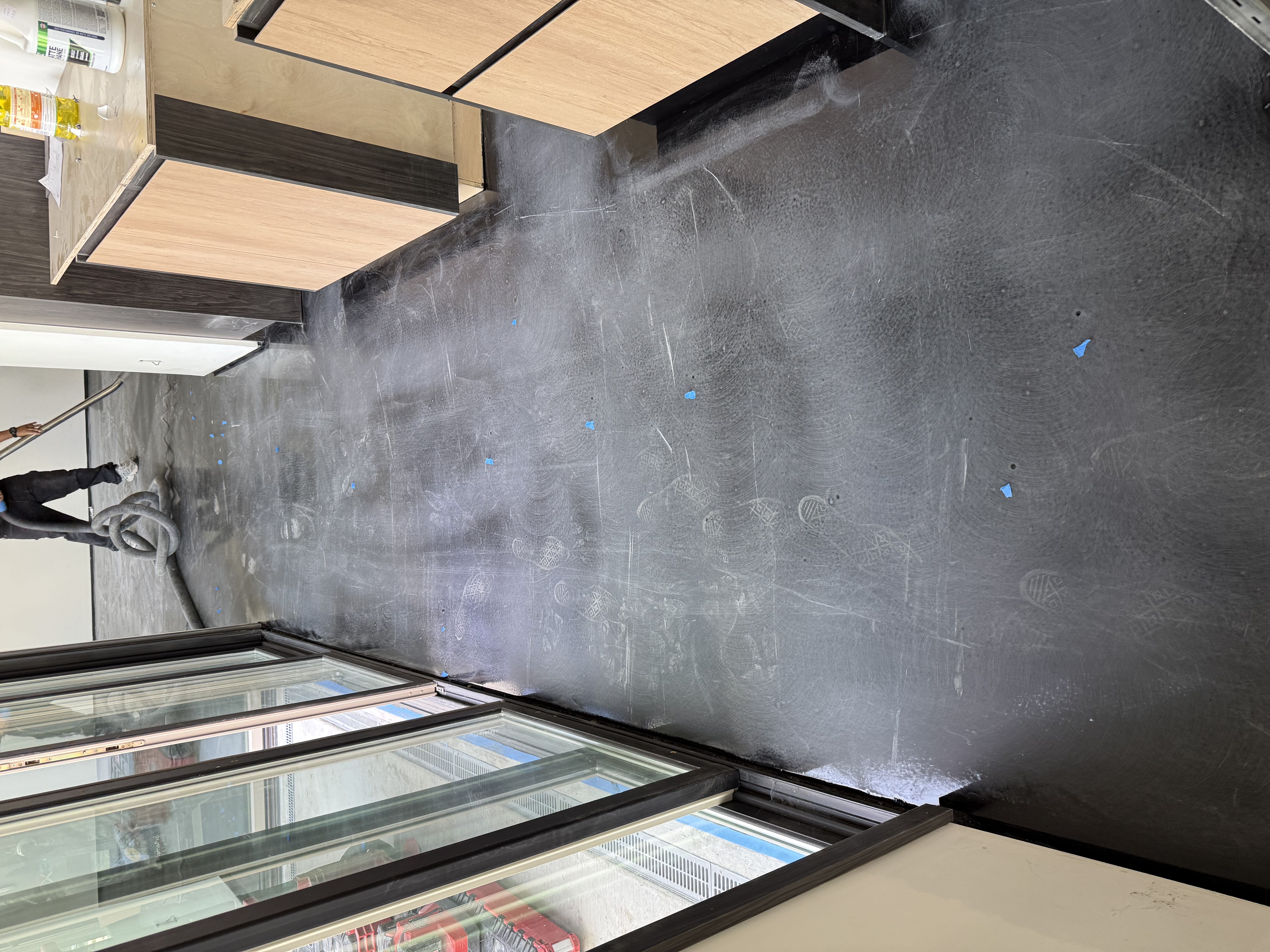 Red and black metallic epoxy garage floor with dramatic swirl