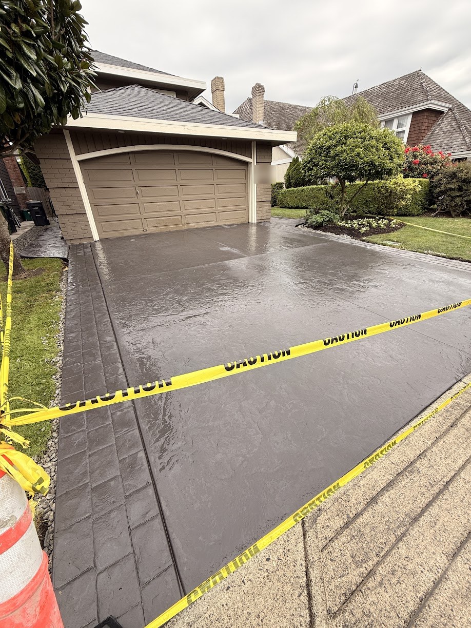 Finished stamped concrete driveway in a charcoal colour with a stamped border in Steveston, Richmond BC