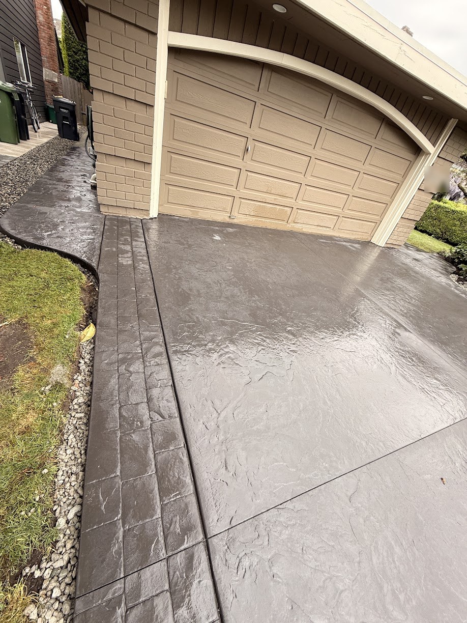 Close-up of a stamped concrete border in a charcoal colour in Steveston, Richmond BC
