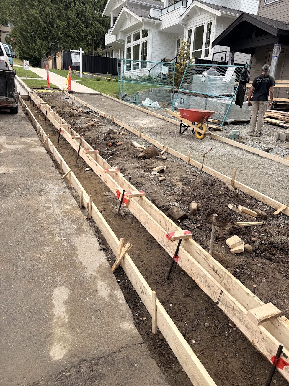 Forms set after demolition and ground prep for a new City sidewalk and curb in the City of North Vancouver