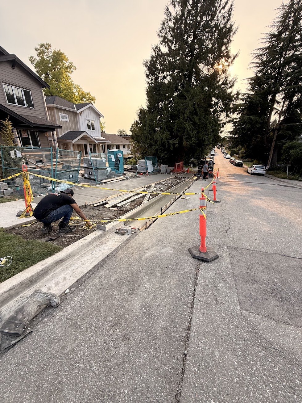 Site taped off while the new City sidewalk and curb cure in the City of North Vancouver
