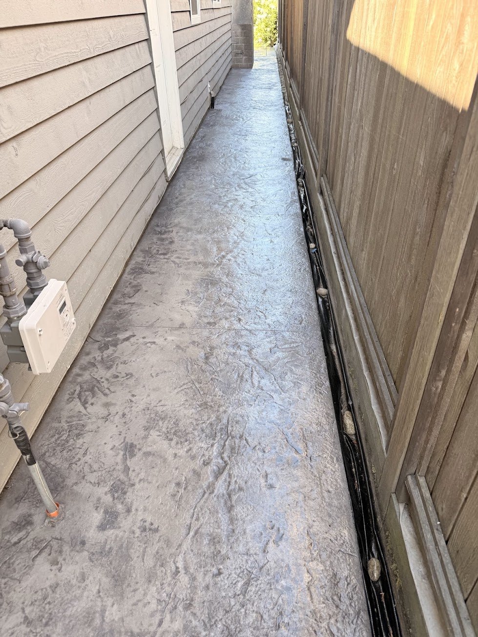 Side yard stamped concrete walkway with a stone texture in Steveston, Richmond BC