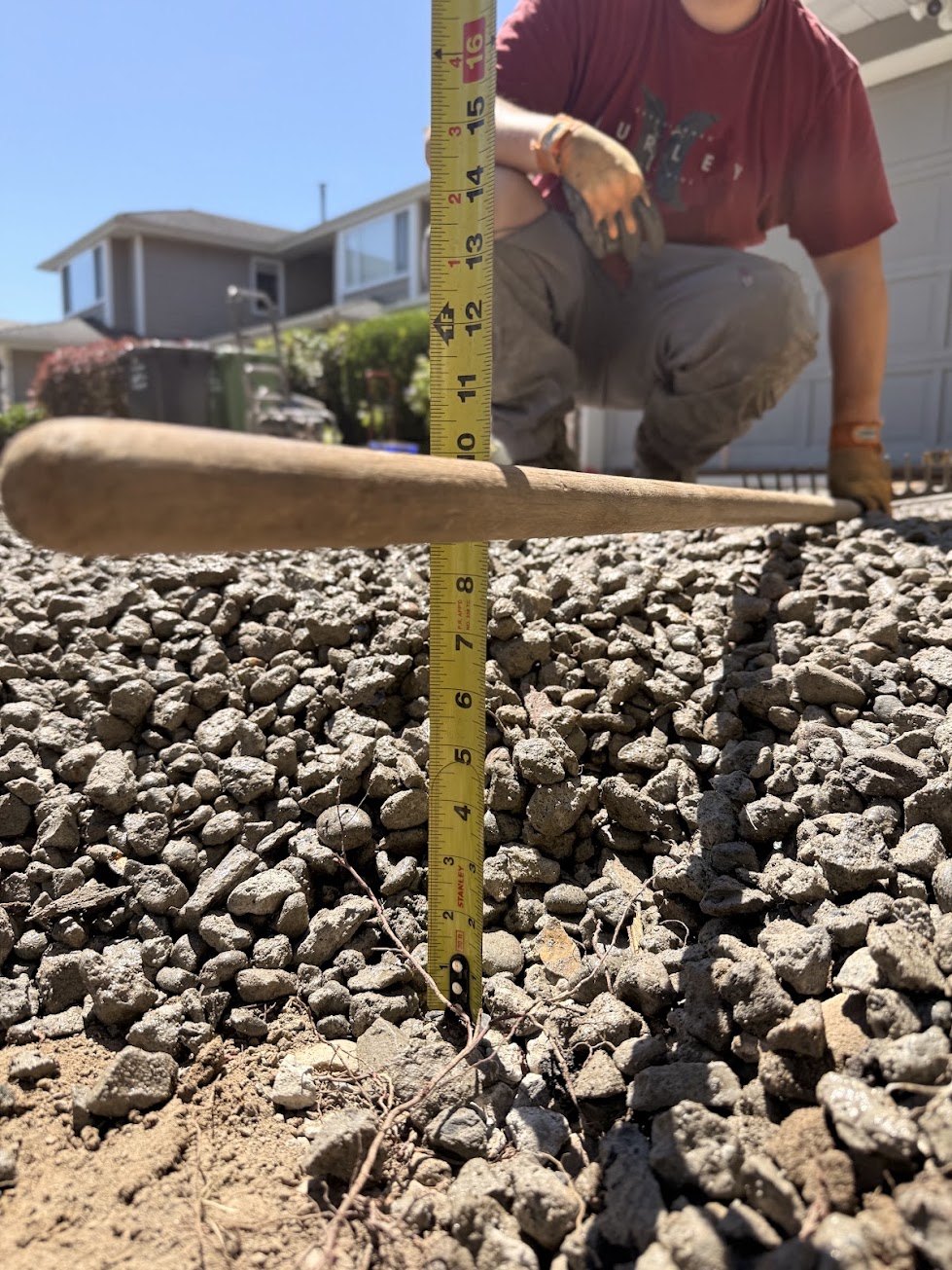 Checking base depth before forming and pouring concrete in Steveston, Richmond BC