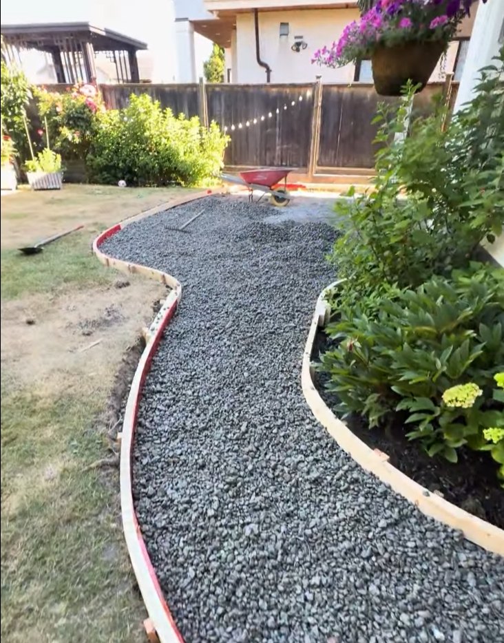 Curved concrete walkway forms set on a compacted gravel base in Steveston, Richmond BC