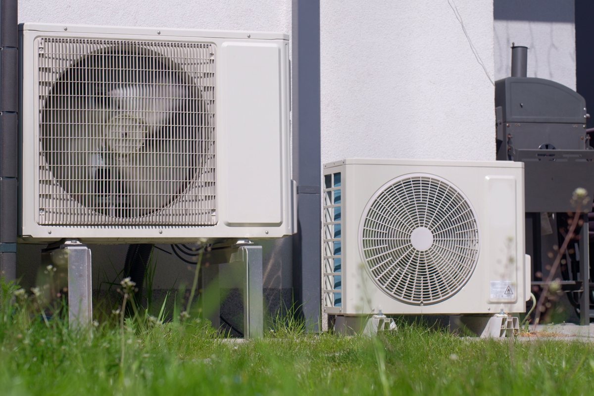 Heat pump outdoor units beside a house