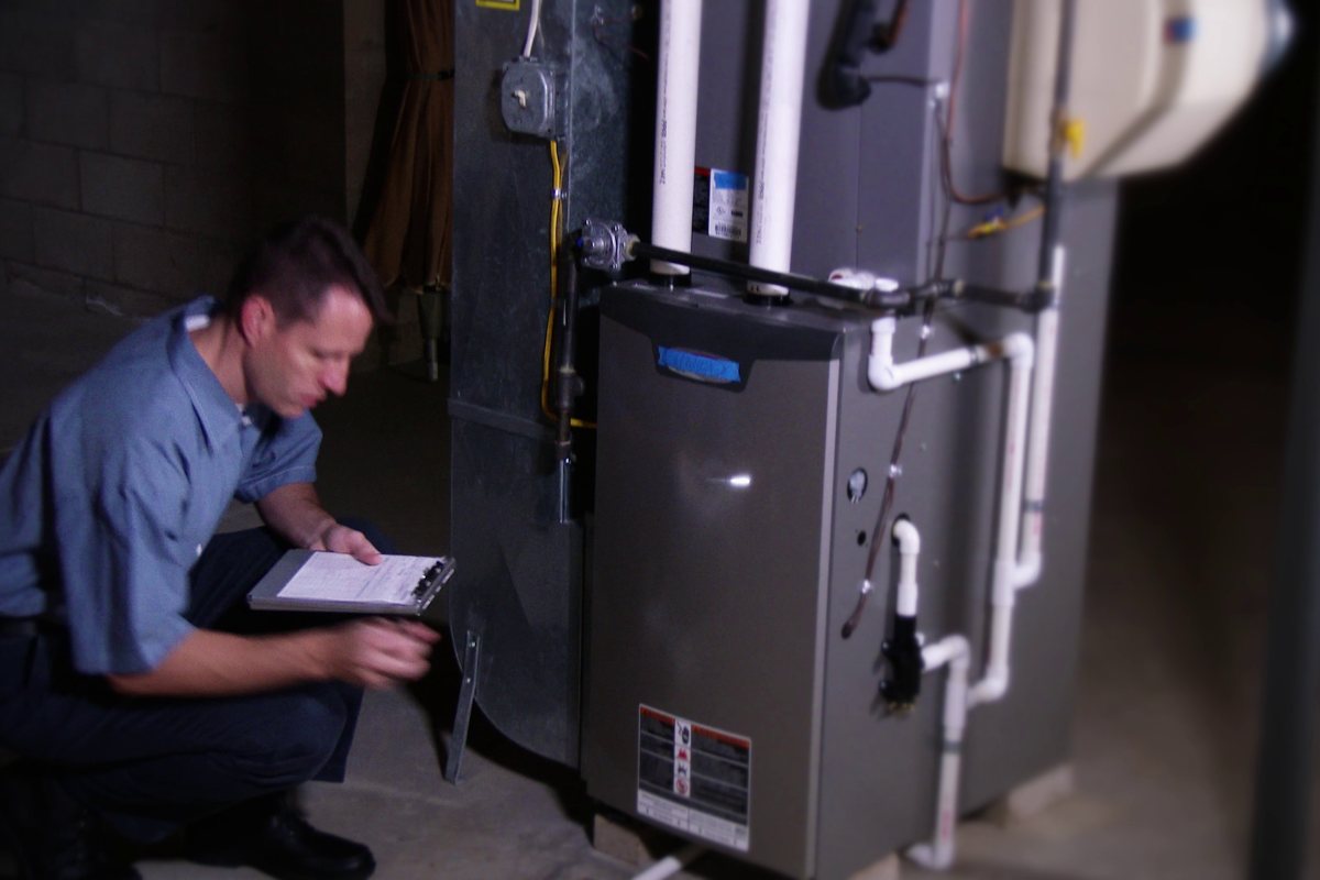 Technician inspecting a gas furnace