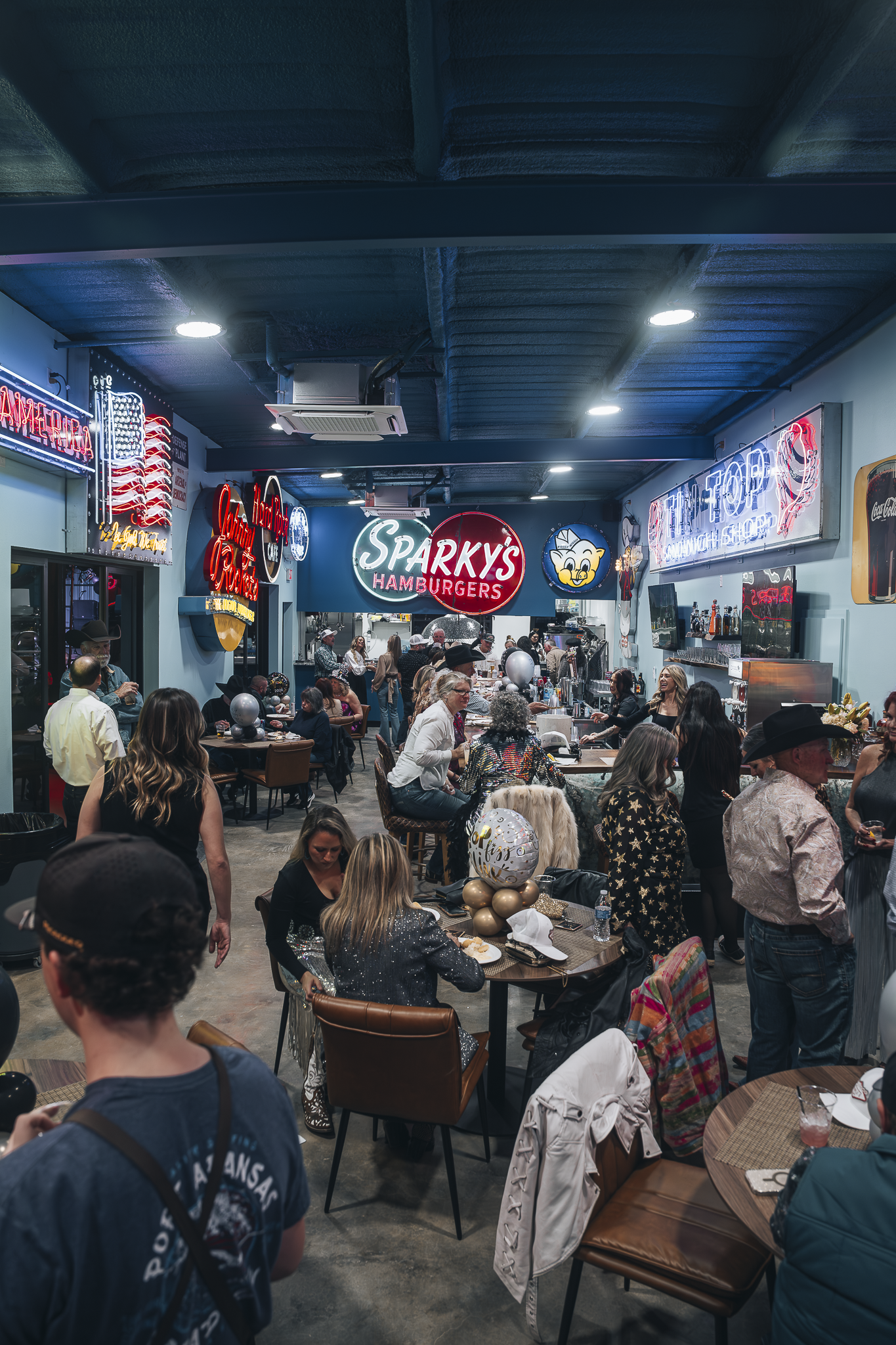 Double E Lifestyle event at Sparky's Hamburgers, Texas, featuring guests and festive decorations.