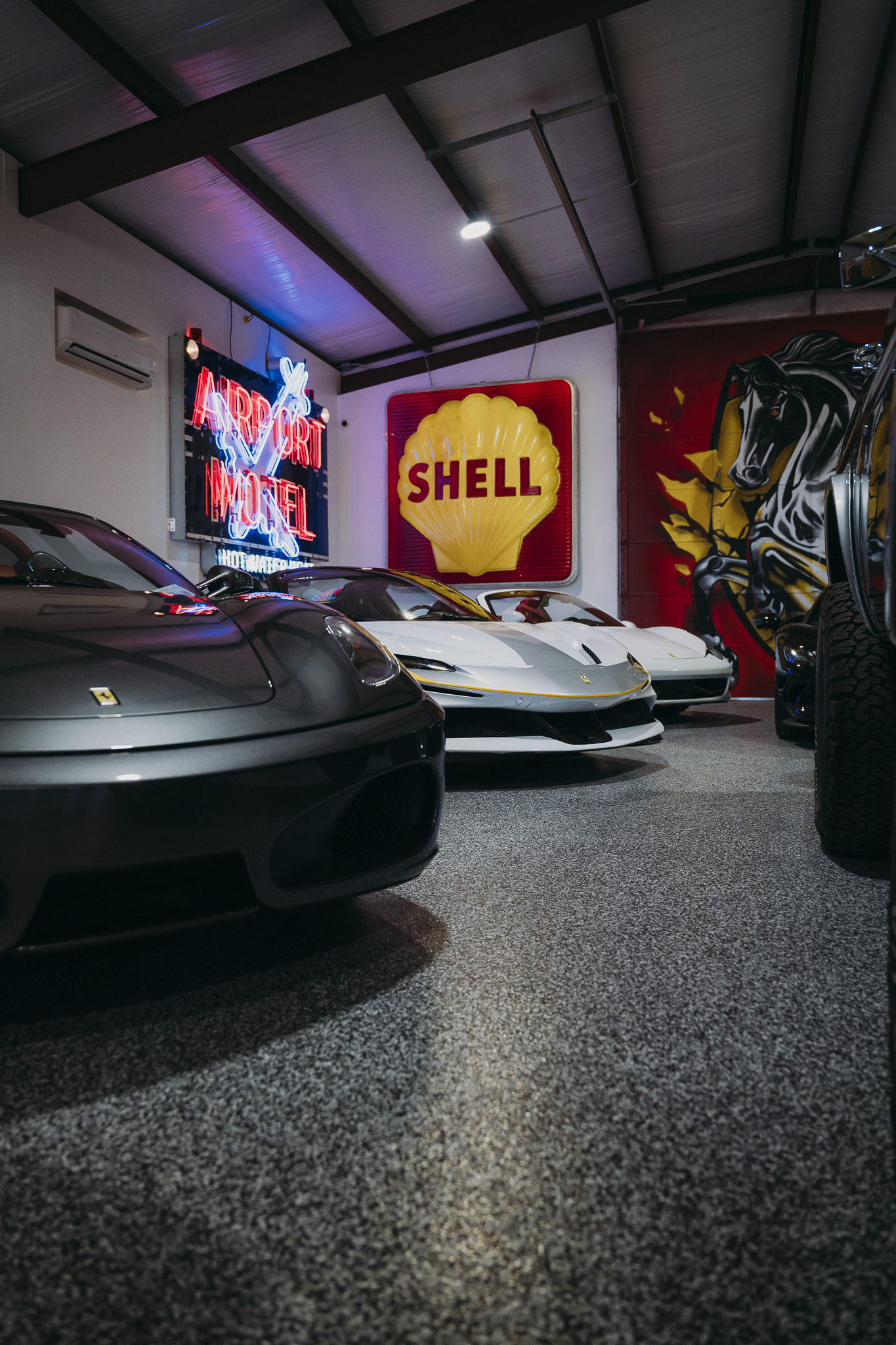 Double E Lifestyle event showcasing luxury cars and vintage signage in Texas.