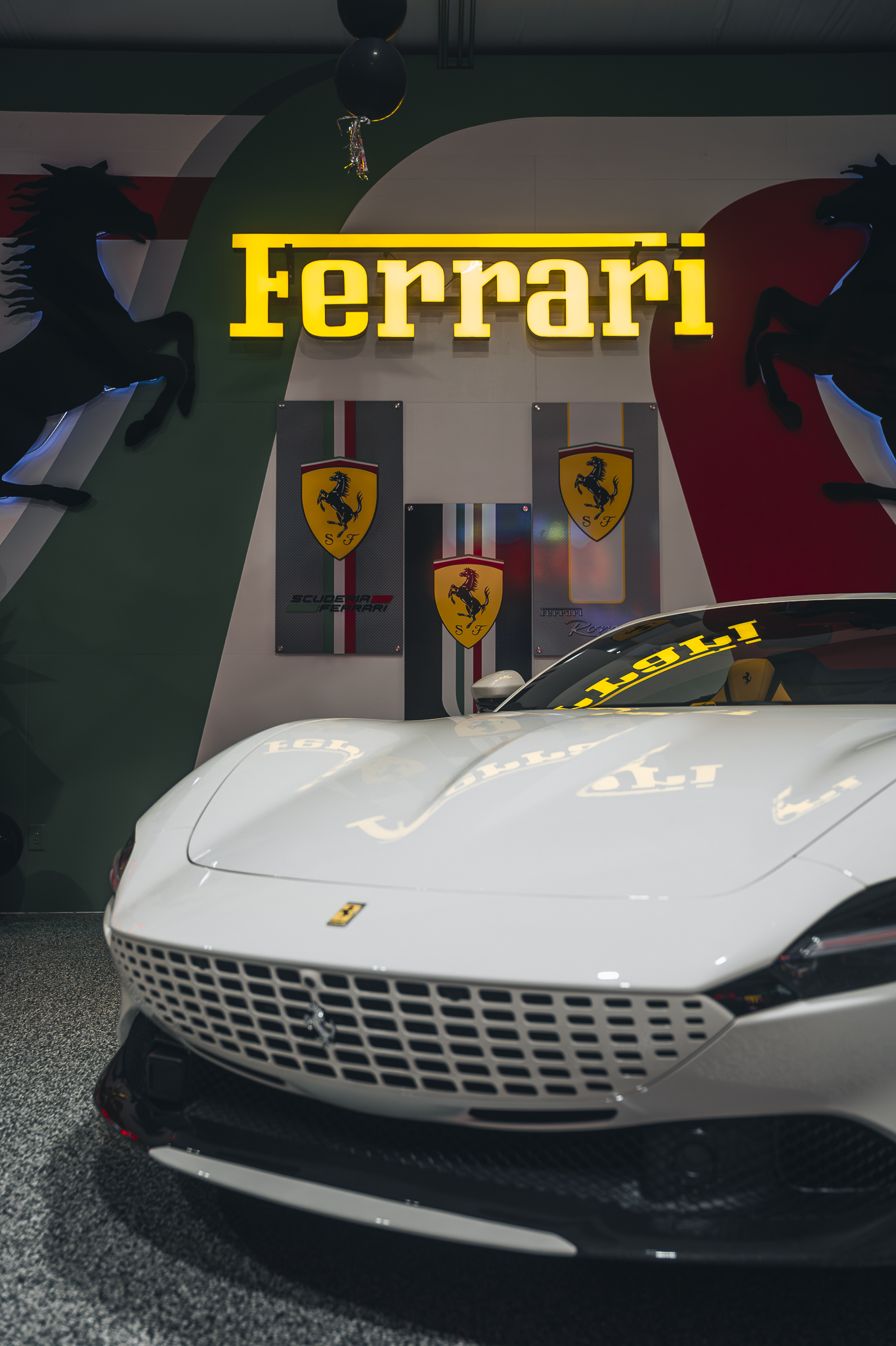 Double E Lifestyle event featuring a white Ferrari and Ferrari branding.