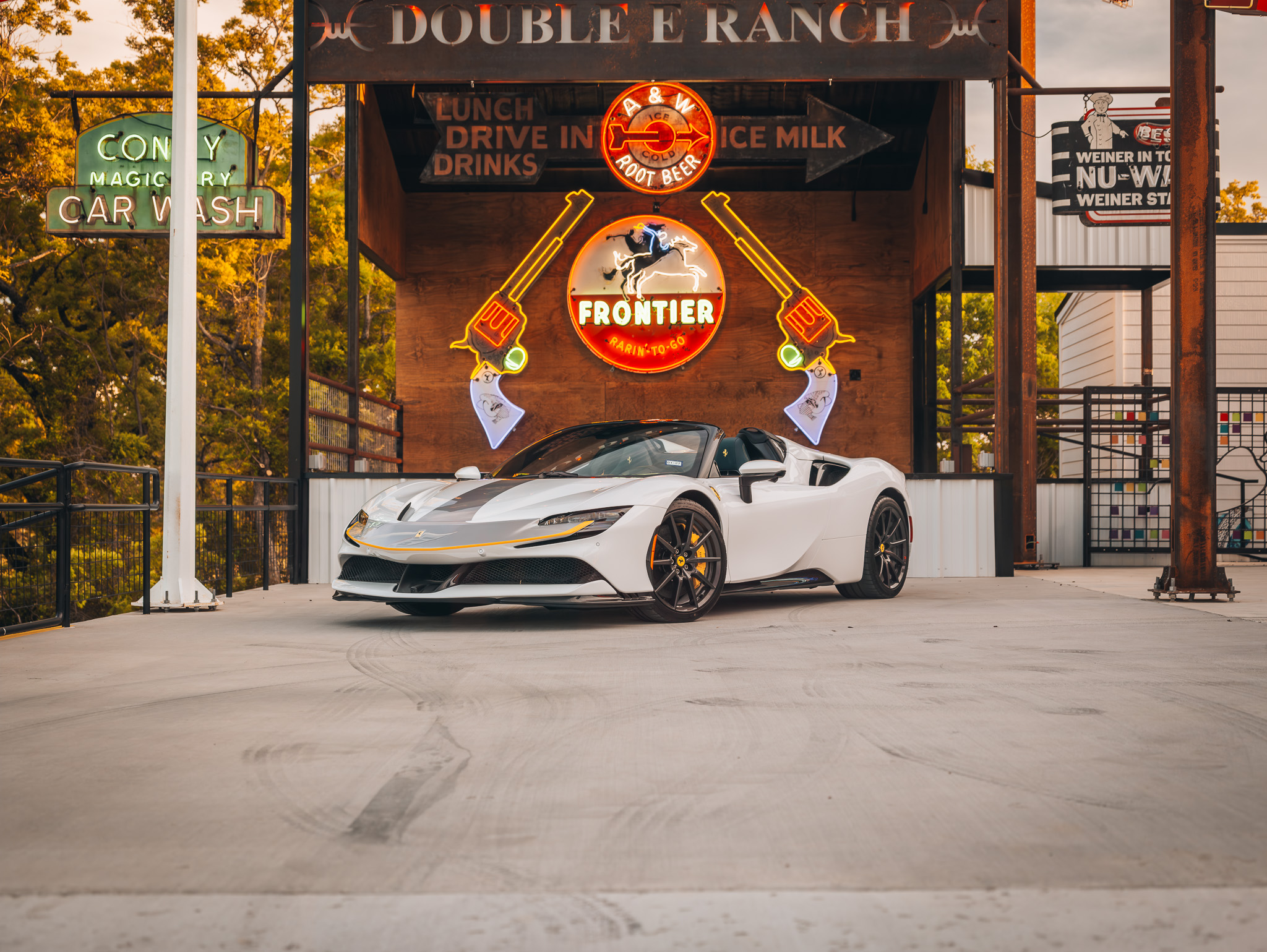 Double E Ranch & Venue entrance with luxury car and vintage signage showcasing Texas experiences.