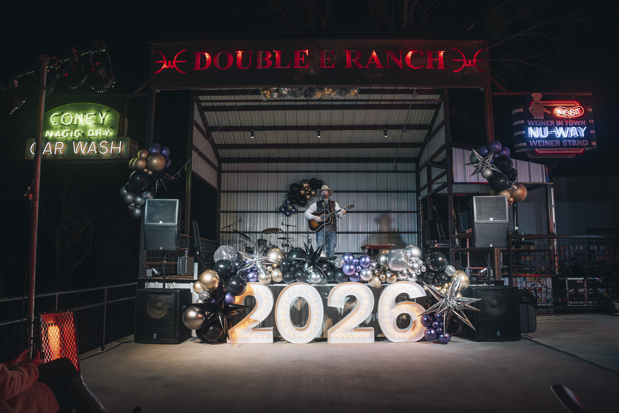 Double E Ranch venue stage decorated for event with balloons and 2026 display.