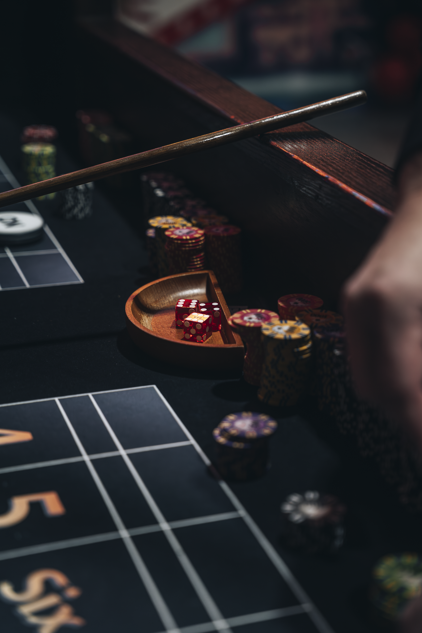 Casino gaming table with dice and poker chips showcasing Double E Lifestyle entertainment experiences in