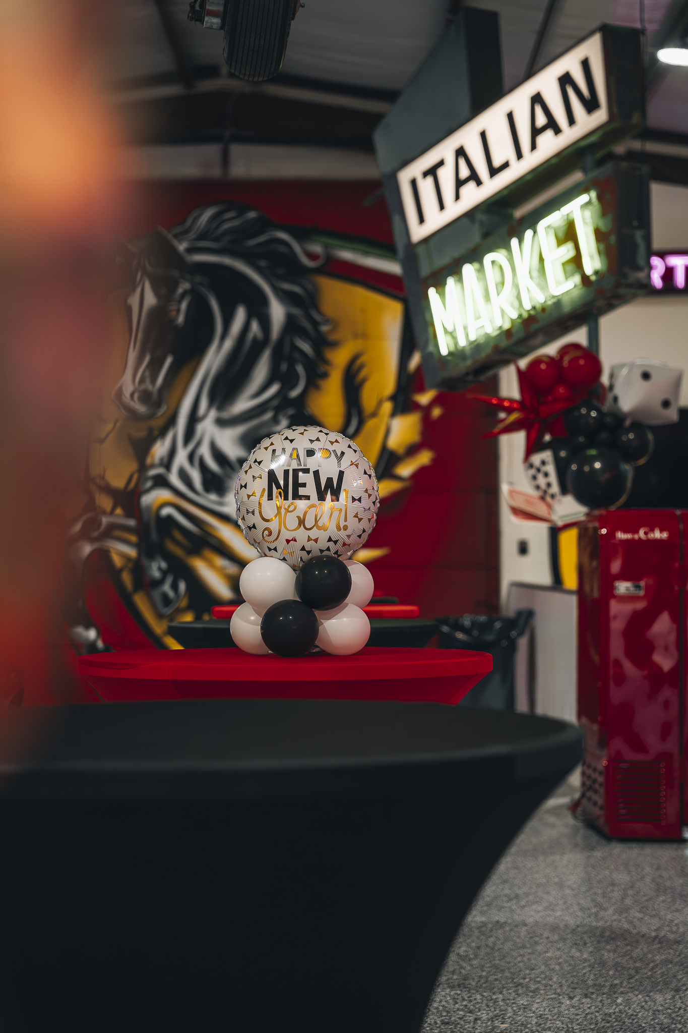 Double E Lifestyle event display with "Italian Market" sign, New Year balloon, and Texas horse