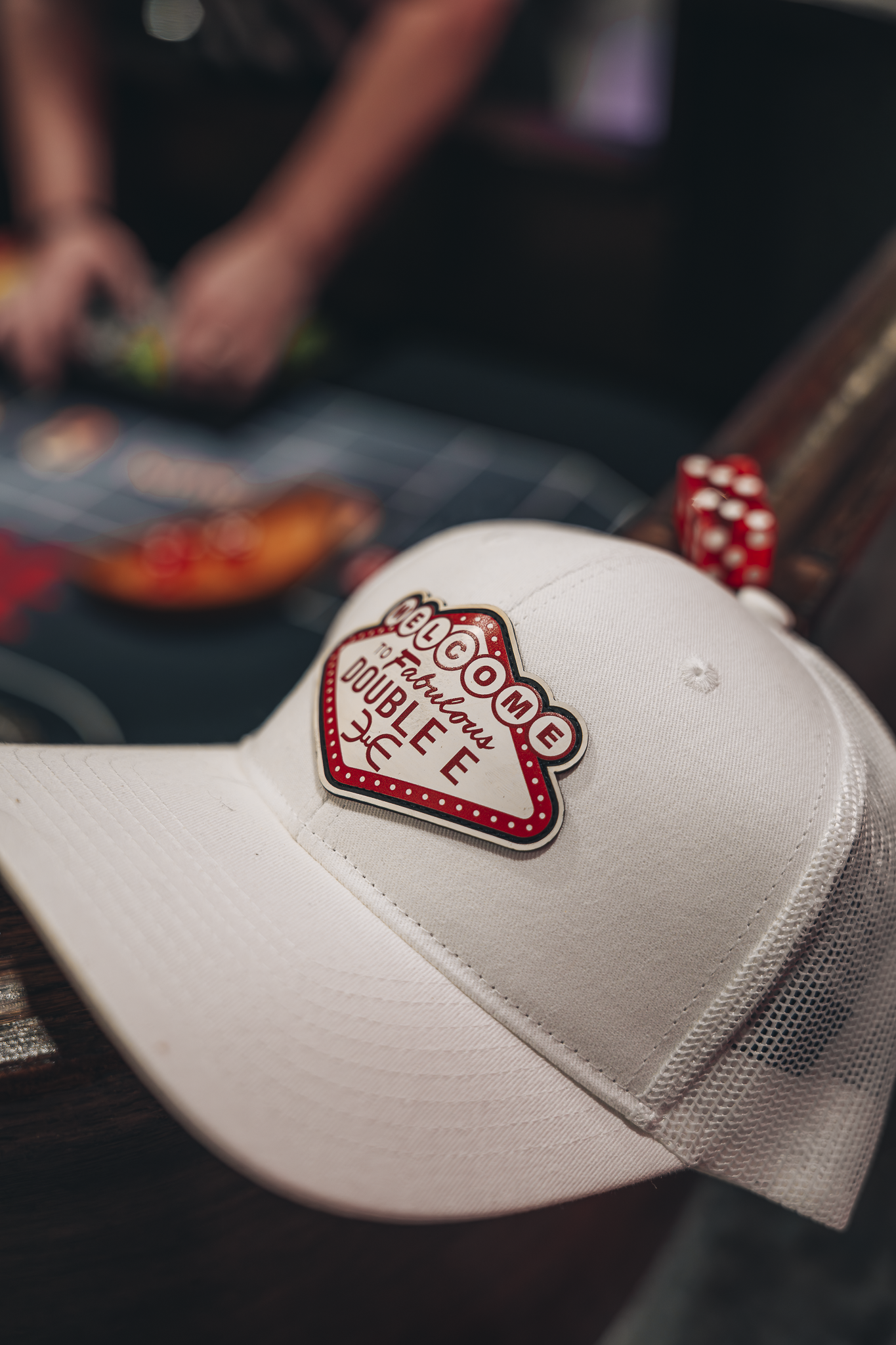Double E Lifestyle branded hat with "Welcome Fabulous Double E" pin, showcasing events and experiences