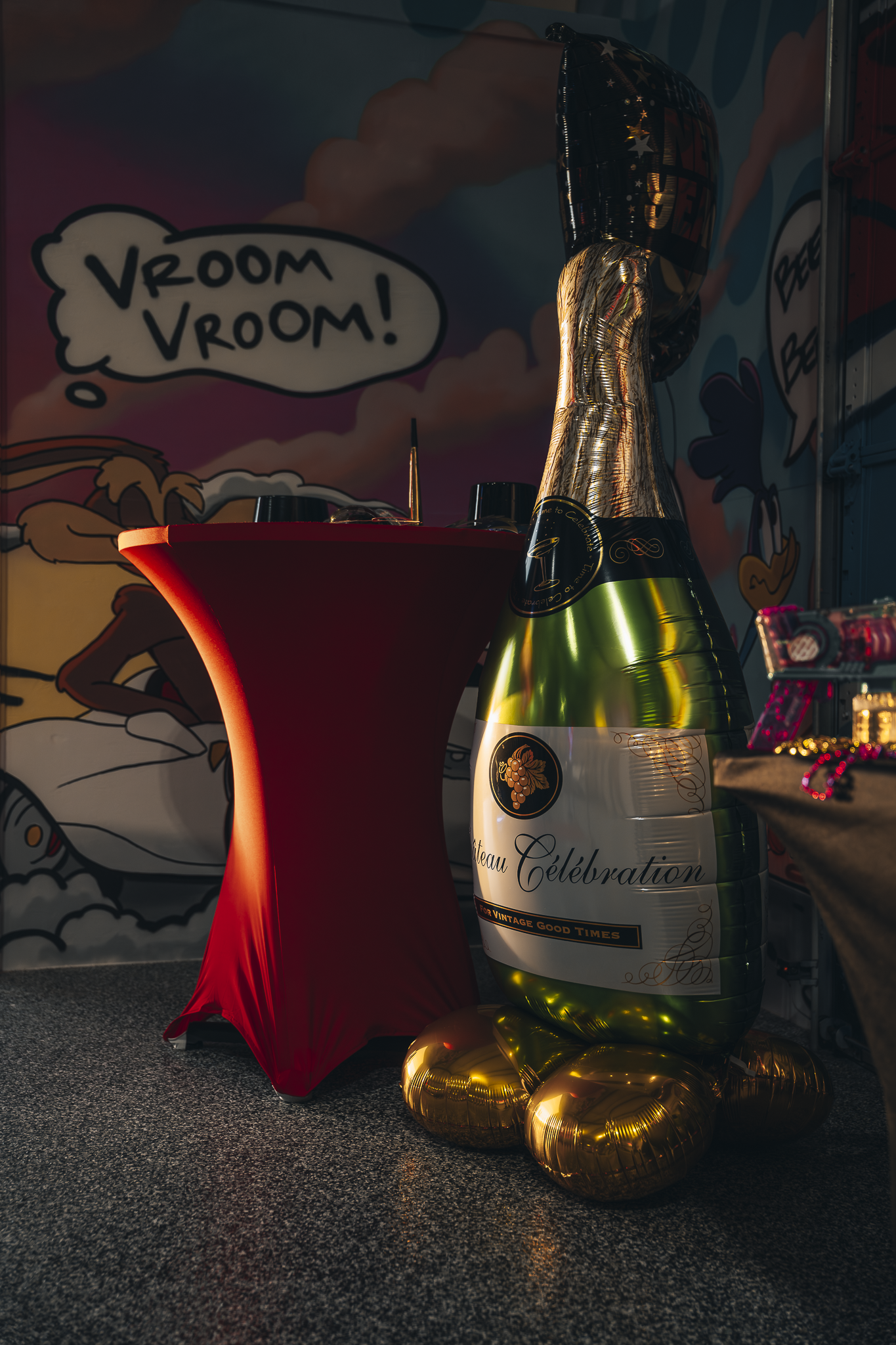 Celebration decor and oversized champagne bottle balloon at Double E Lifestyle event in Texas.