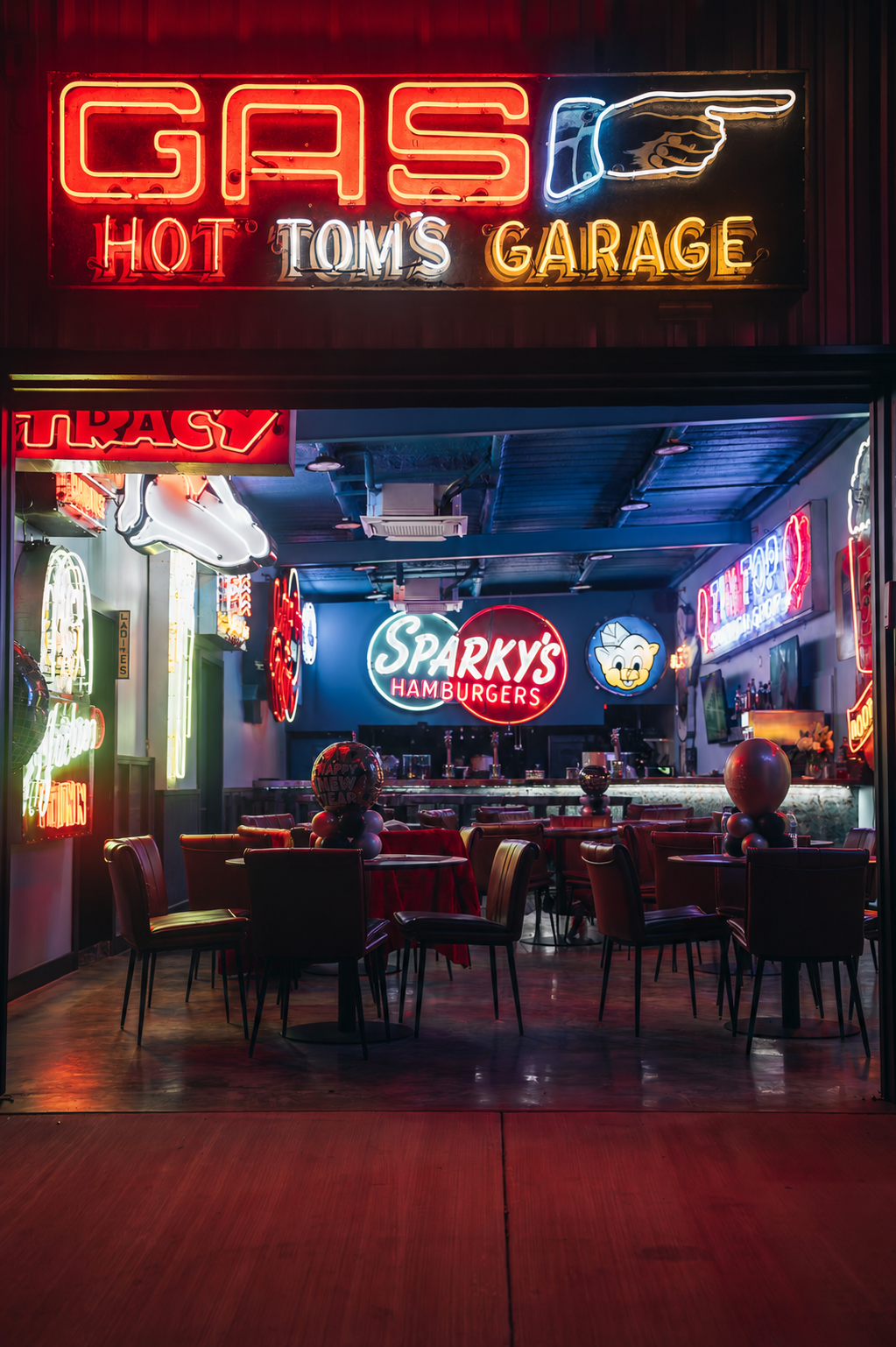 Double E Lifestyle venue featuring GAS HOT TOM'S GARAGE and Sparky's Hamburgers signage, showcasing a