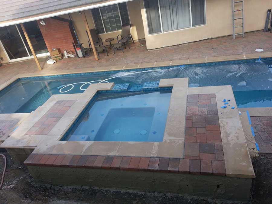 Professional pool demolition service safely removing backyard swimming pool