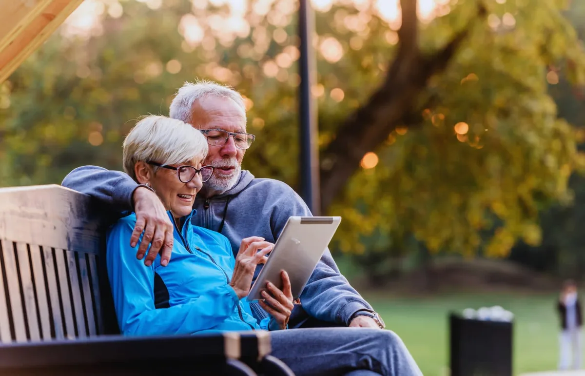 Retired couple reviewing their Medicare plan on a tablet