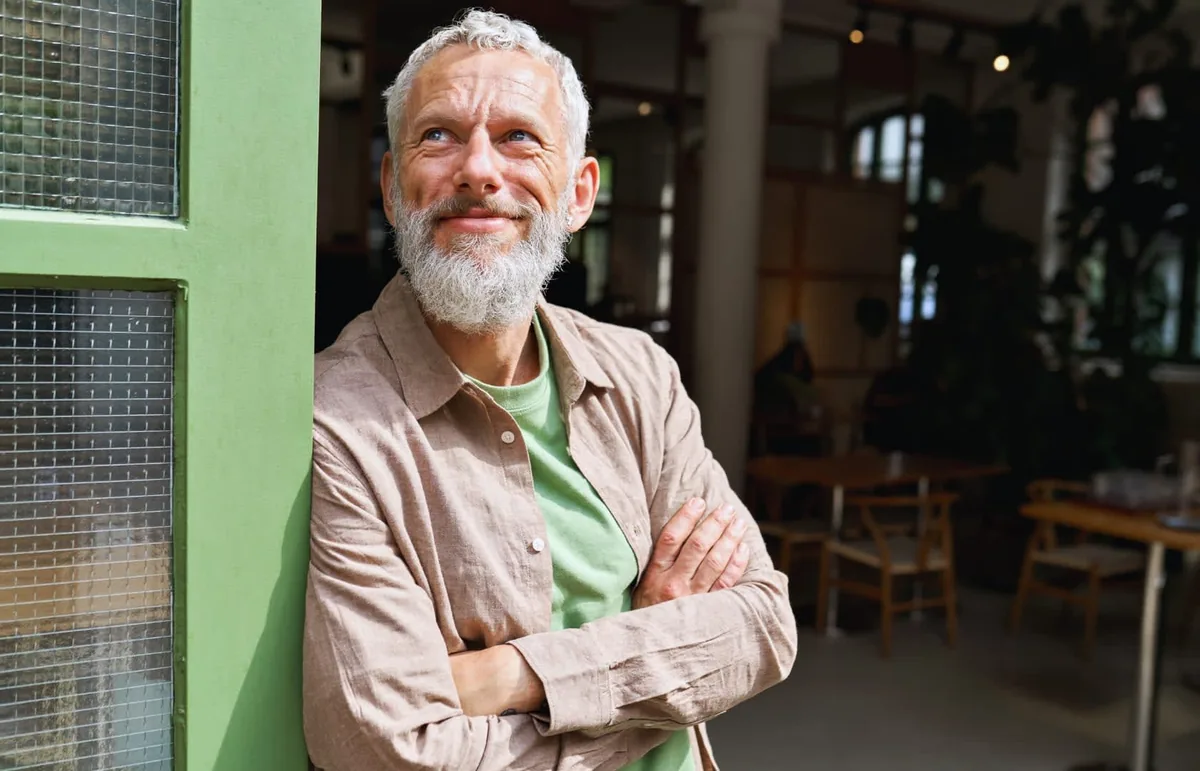 Man in his mid-sixties thinking about Medicare enrollment