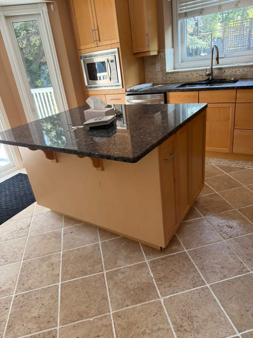 Kitchen countertops and island after residential cleaning in Calgary