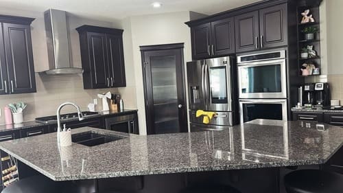 Kitchen countertops and island after residential cleaning in Calgary