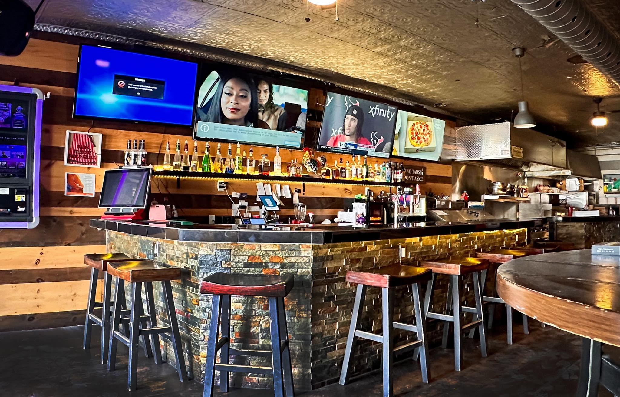 The bar at Spot 23 with TVs showing live sports