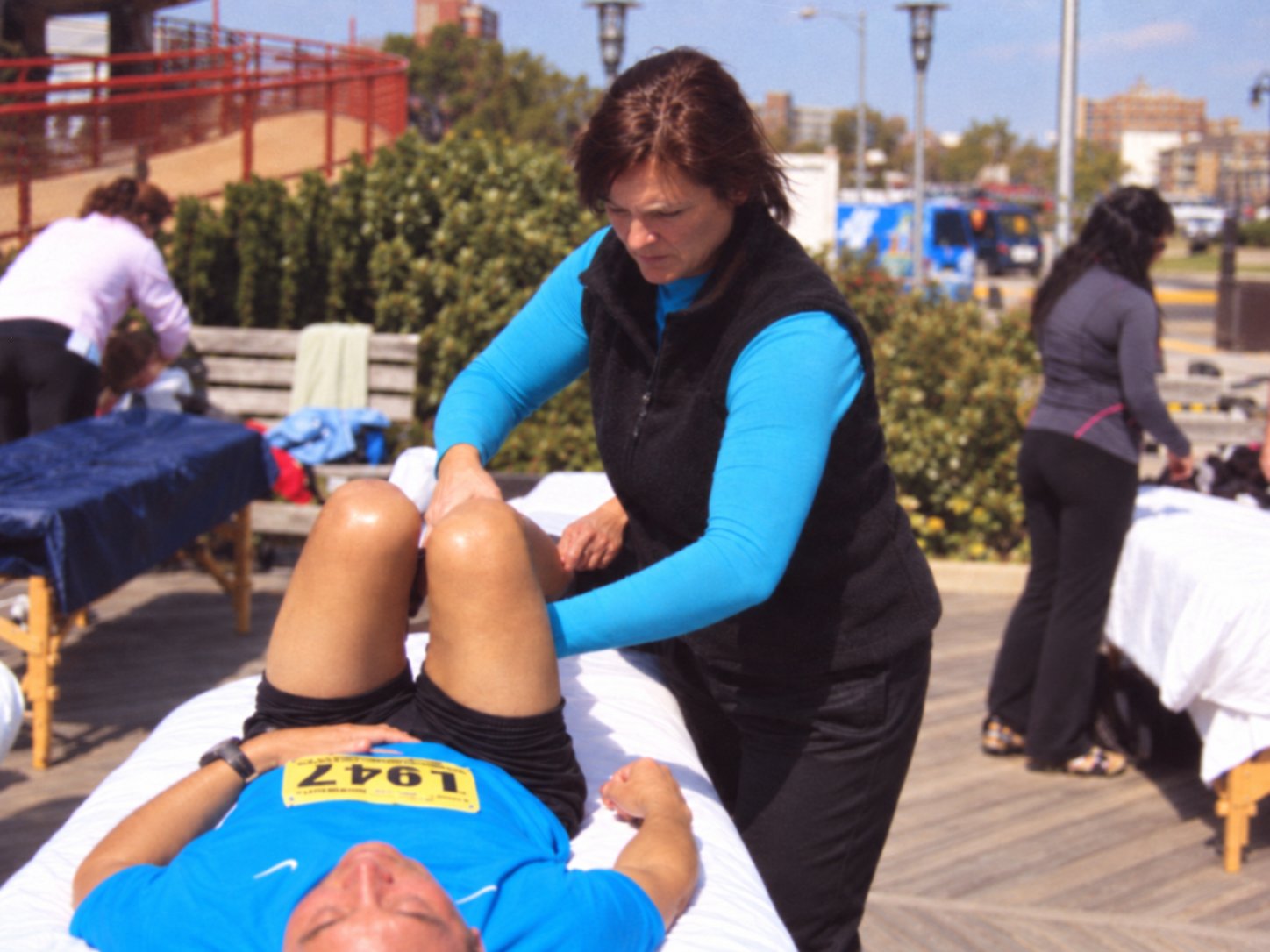 Mary working on a runner’s legs at a post-race recovery tent on the boardwalk