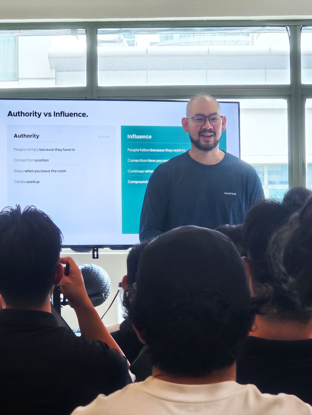 Samuel Tan speaking at a leadership event