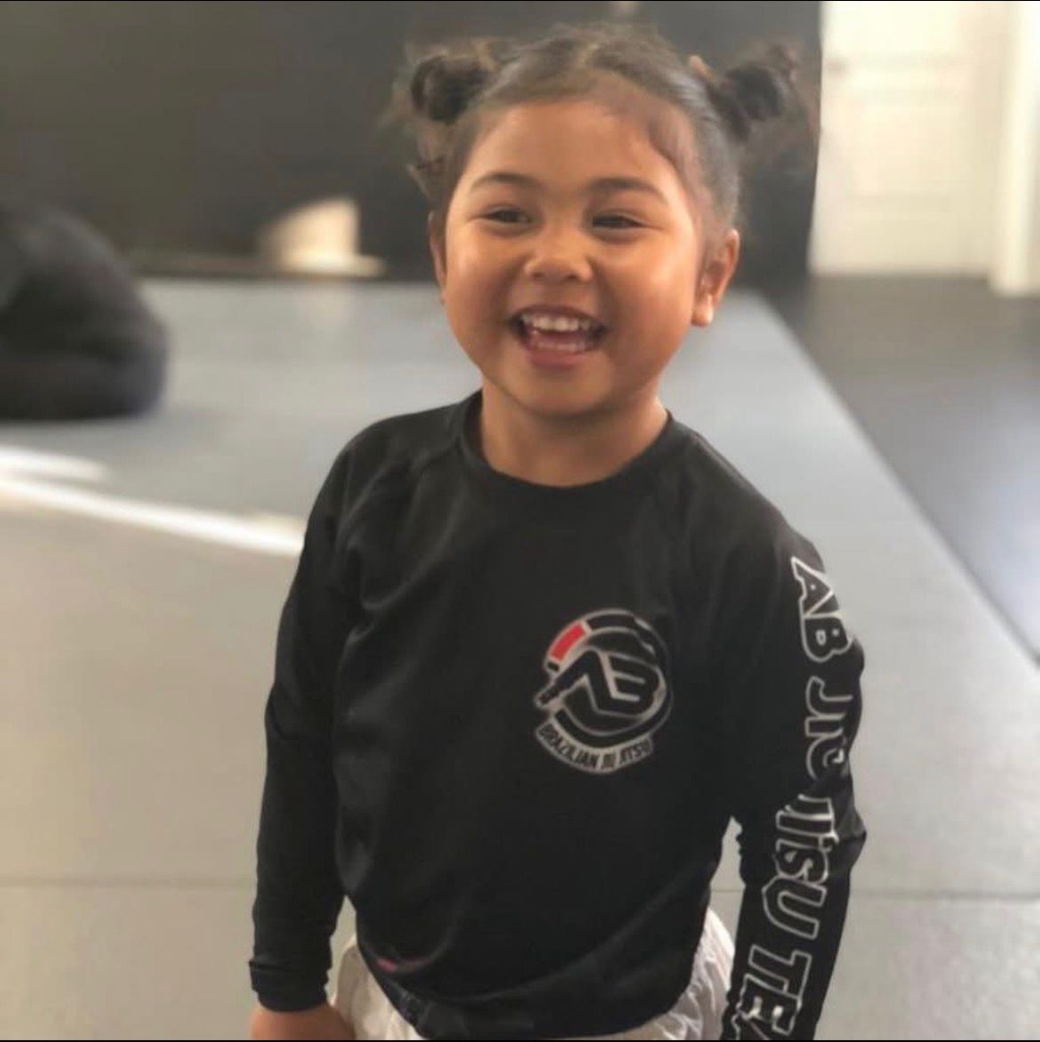 Girl smiling in kids BJJ class at AB MMA