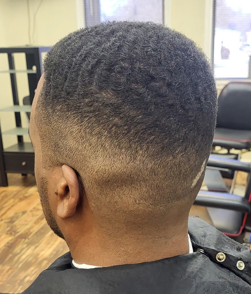 Back view of a low fade with waves on top
