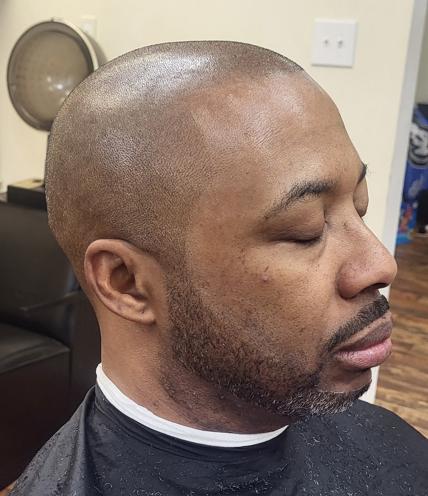 Side profile of a close shave with a tight, lined beard
