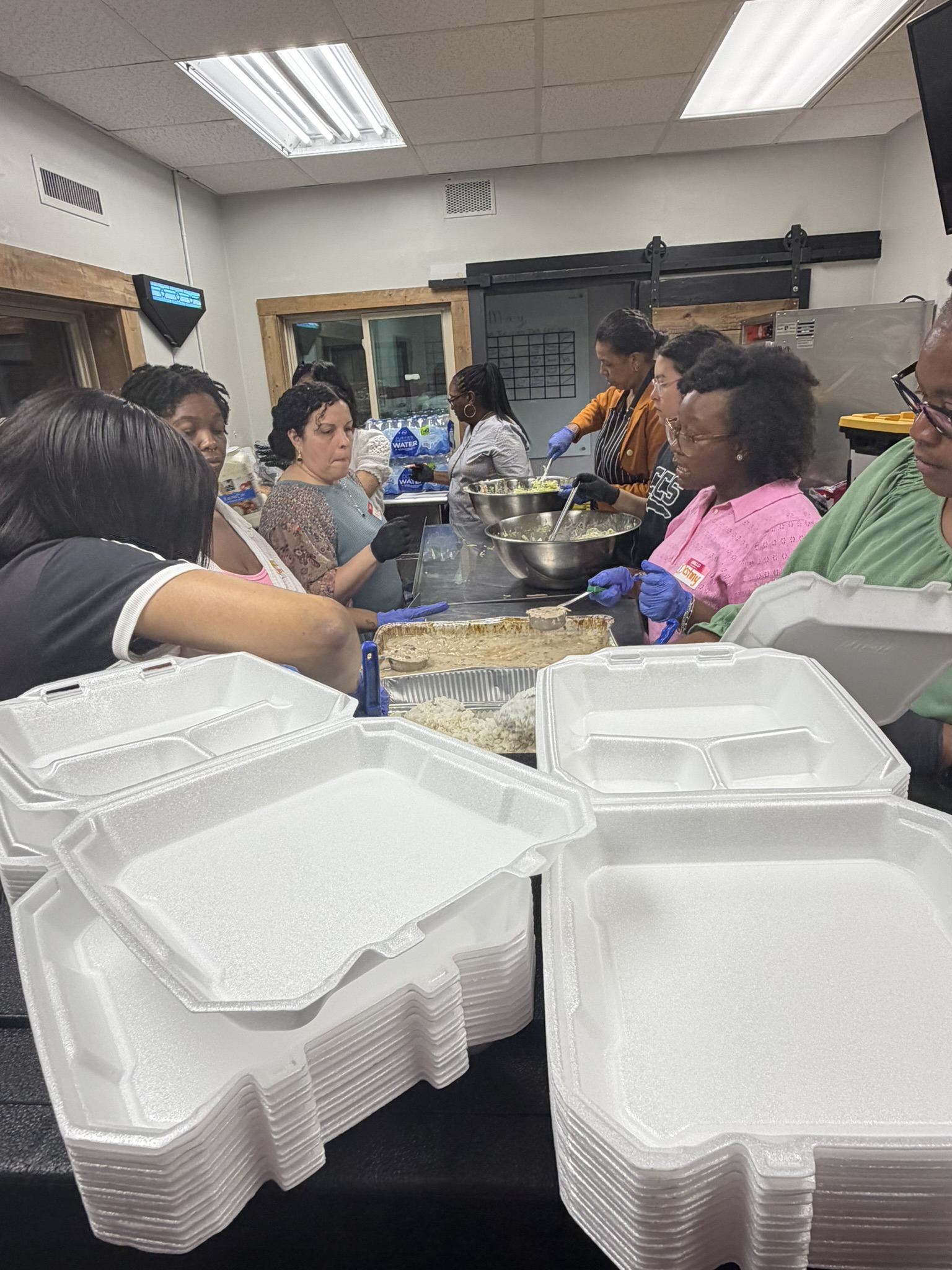 Equipped Daughters volunteers preparing food and supplies for people experiencing homelessness