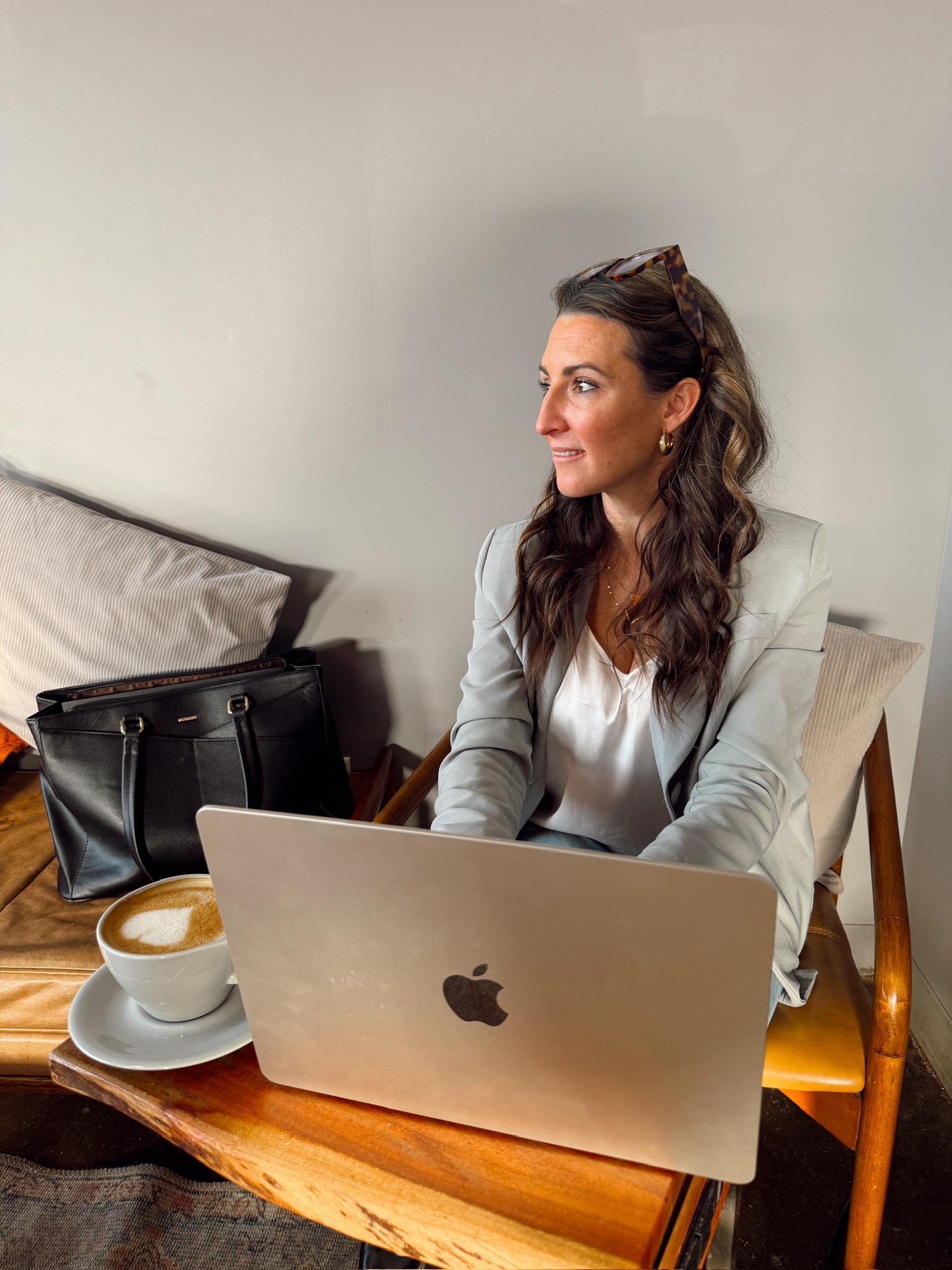 Theresa working at a café with her laptop