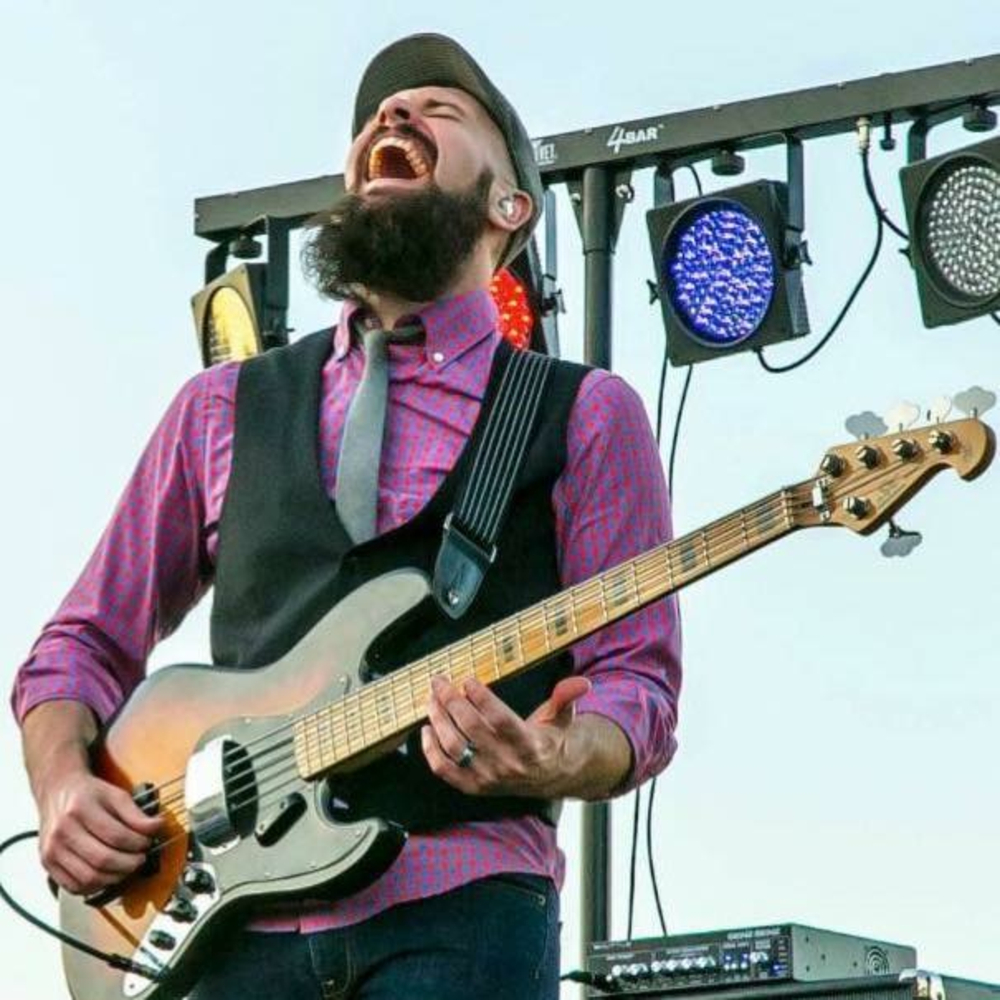 Tony playing bass on stage