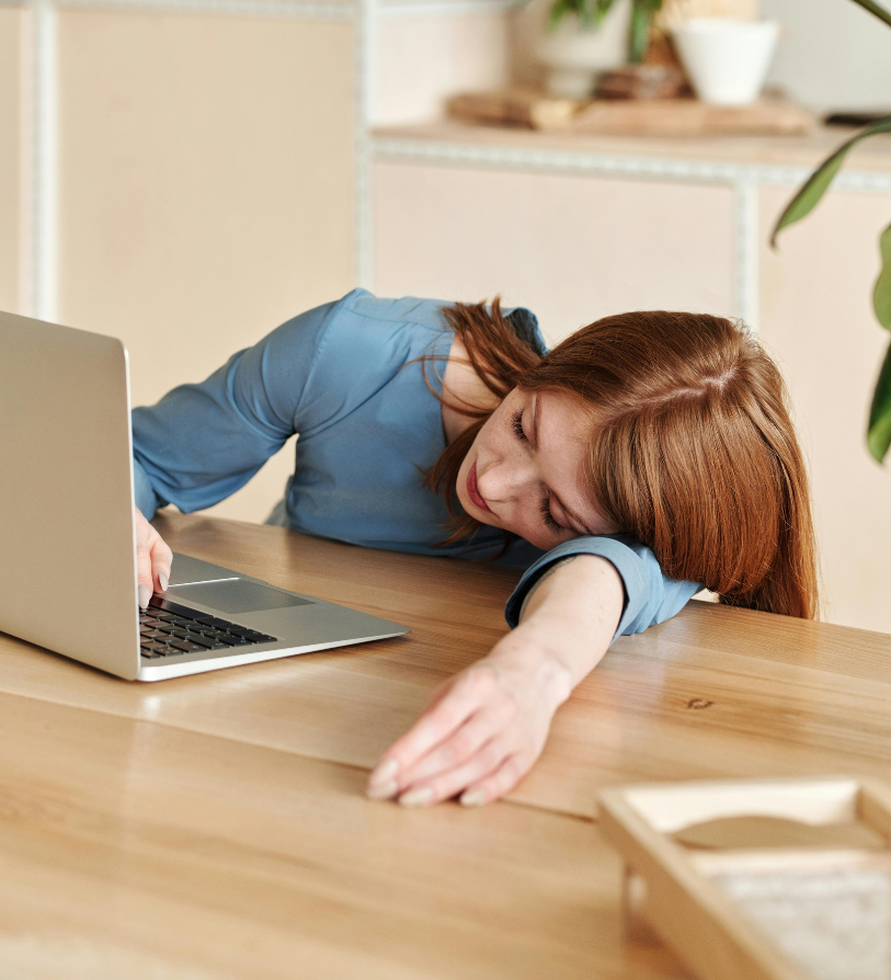 Exhausted mom resting at her laptop
