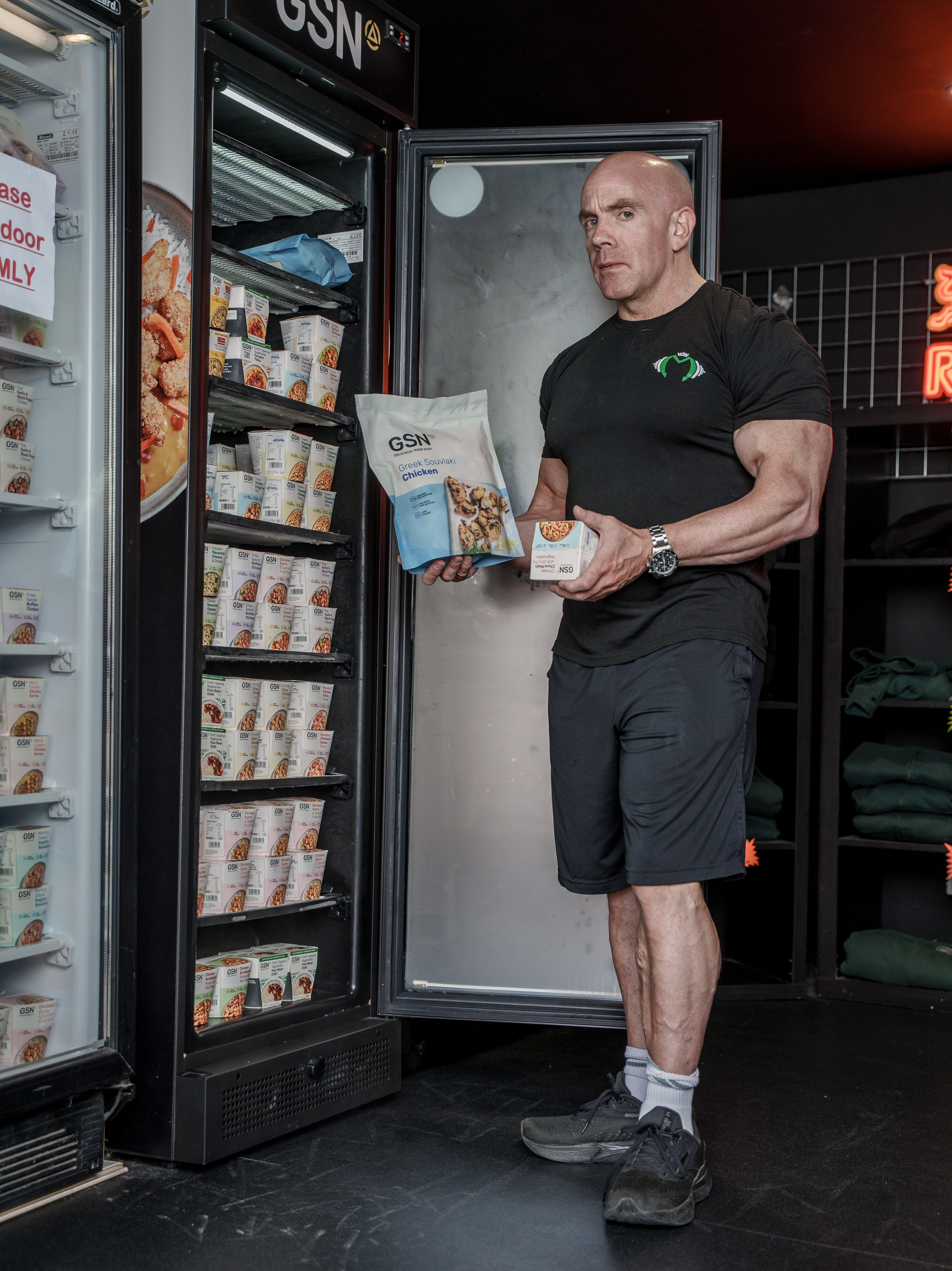 Tom Blackman holding frozen meals sold at the gym counter