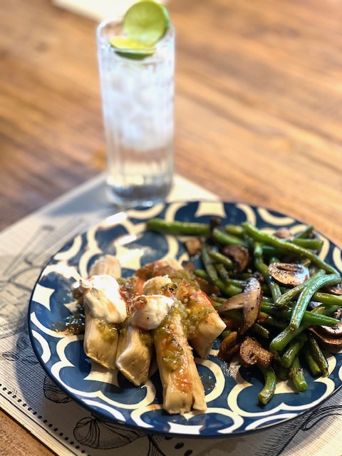 A plate of tamales with green beans.