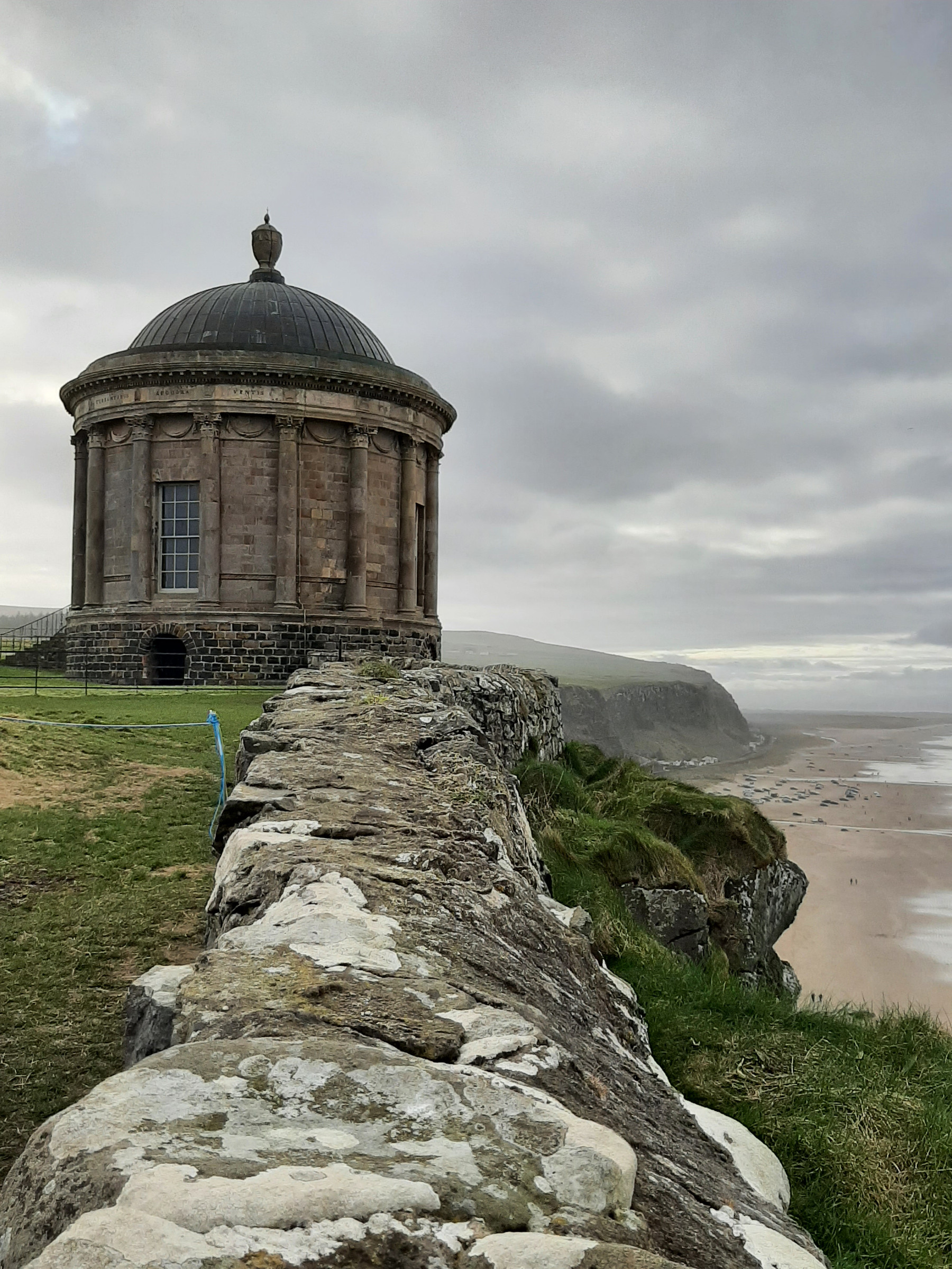 Approach to Mussenden Temple along a stone wall