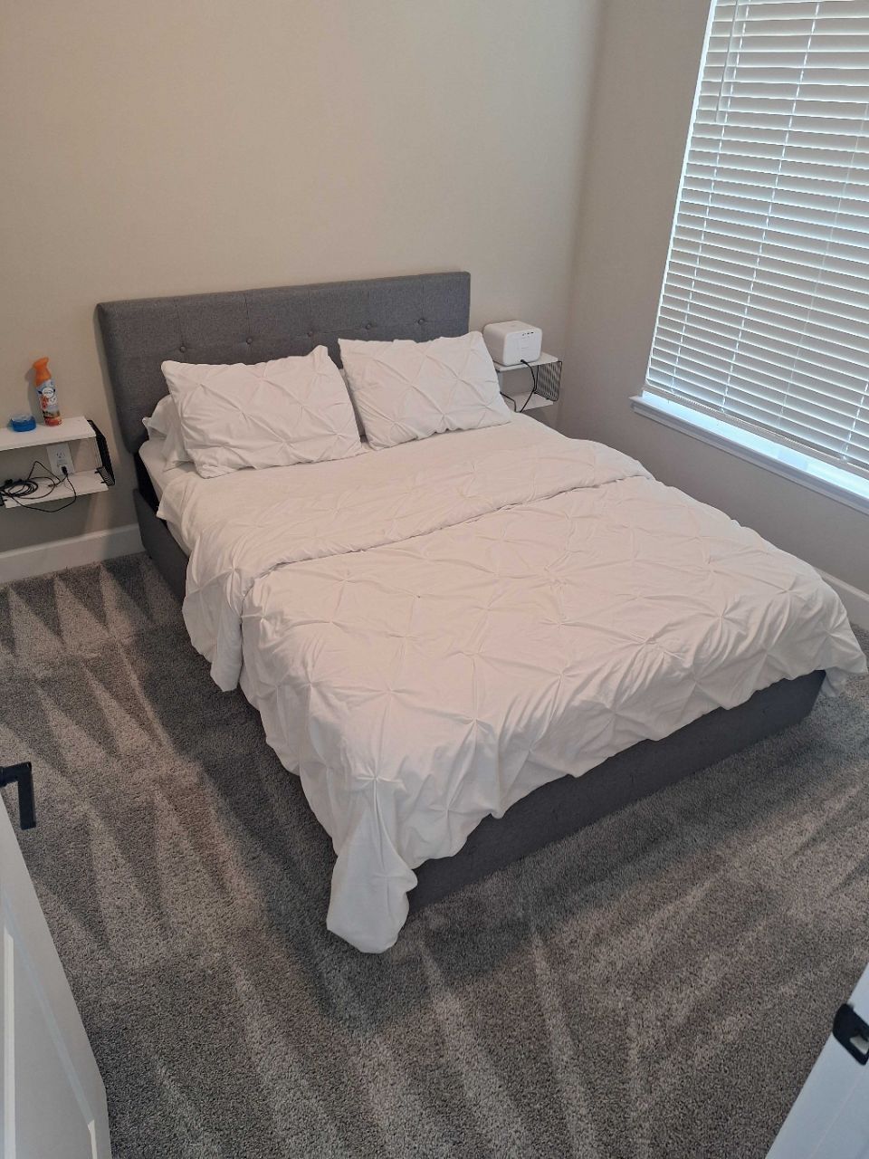 After: same bed made with white linens, room reset by a Keeper