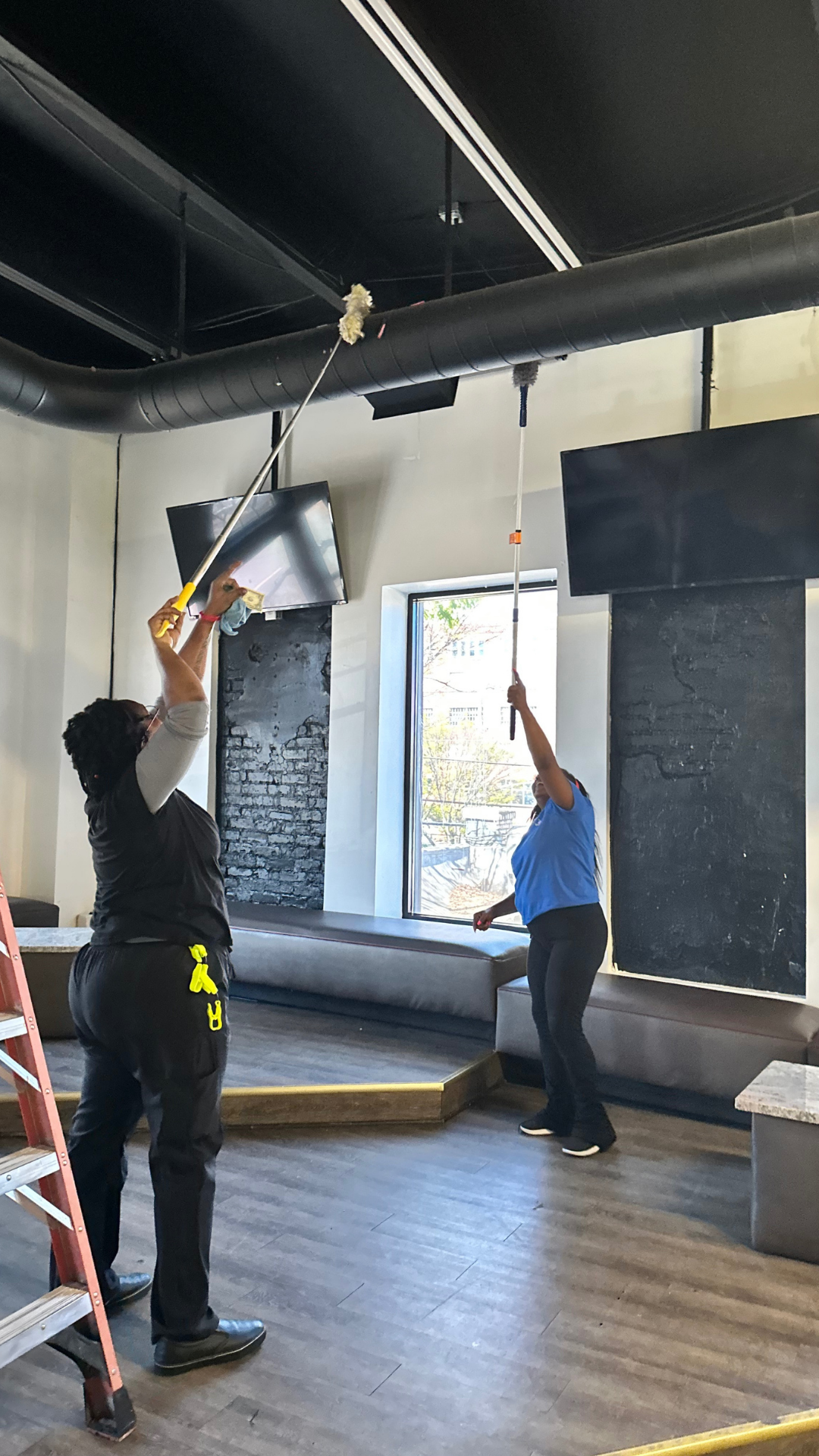 Two Keepers preparing a commercial space before a grand opening
